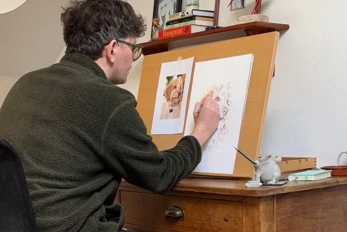 UK pet portrait artist Jonny Atkinson in his studio