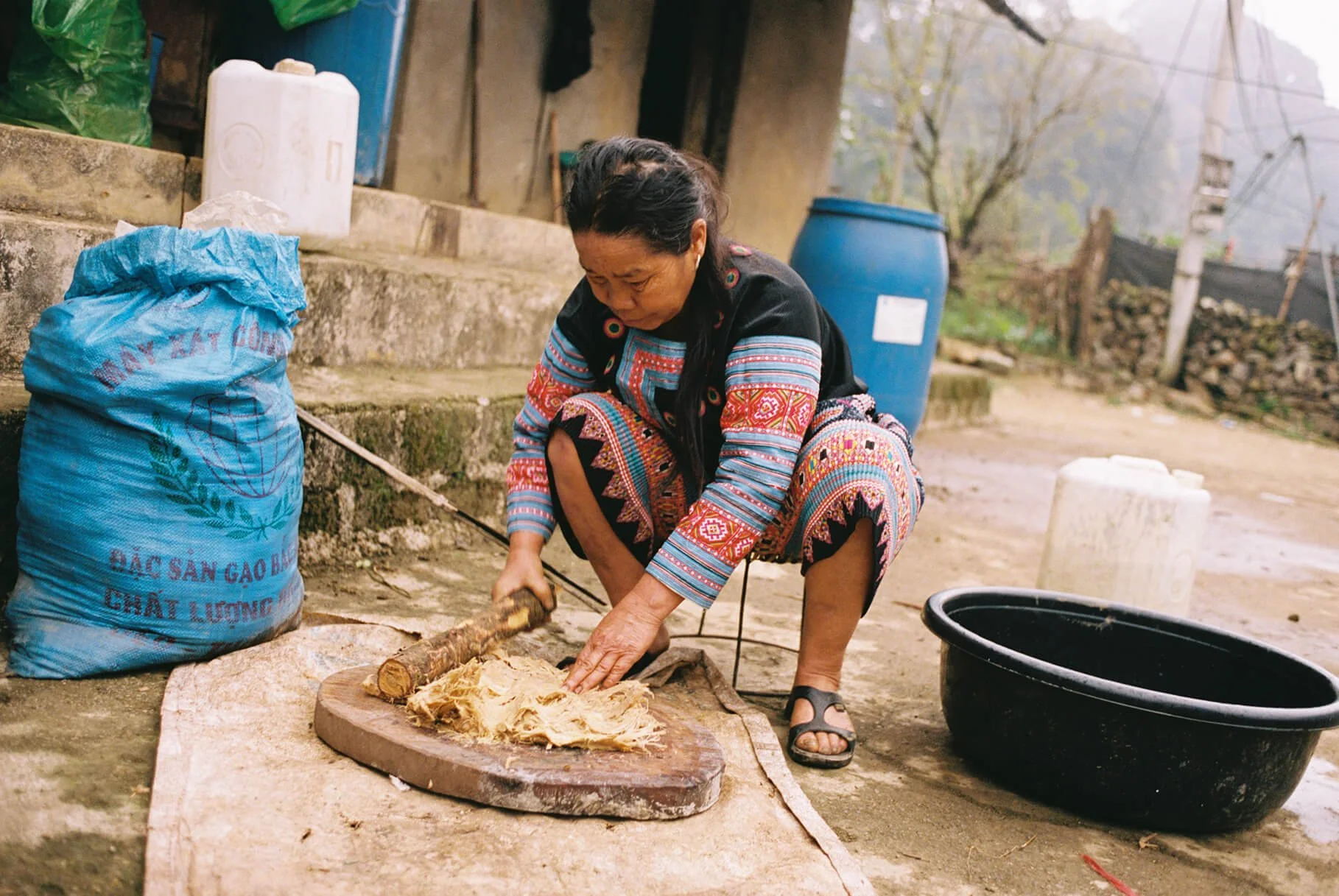 Pounding bamboo with a hand mallet to prepare the pulp for making bamboo paper
