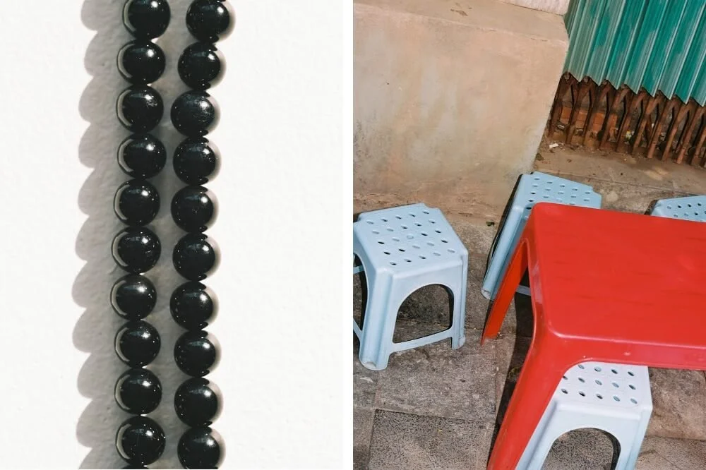 Close-up of a black mala bead necklace on a white background and a small outdoor dining area with blue stools and a red table.