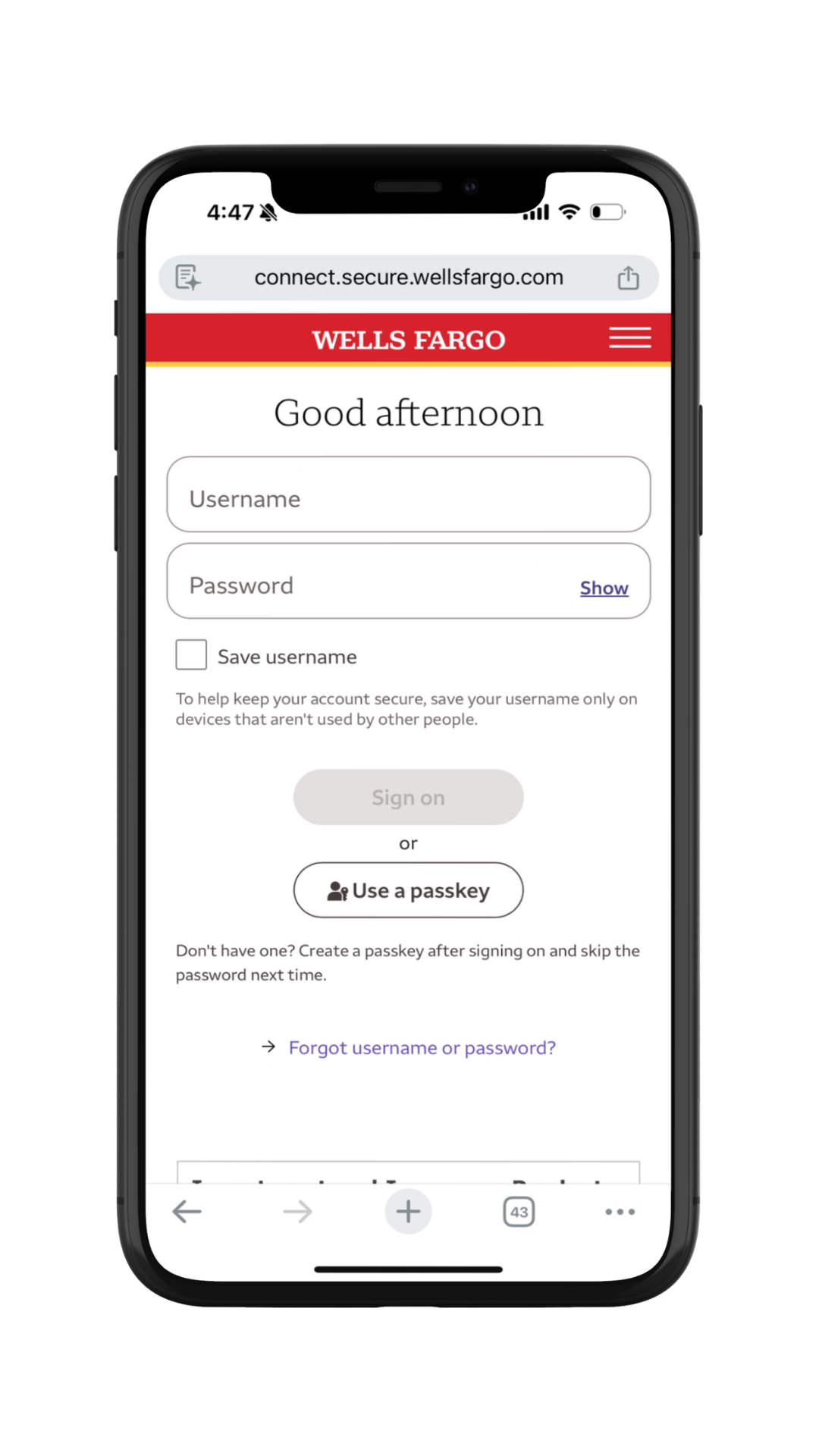 Mobile phone screen displaying the Wells Fargo login webpage with fields for username and password, login button, and options to use a passkey or recover account.
