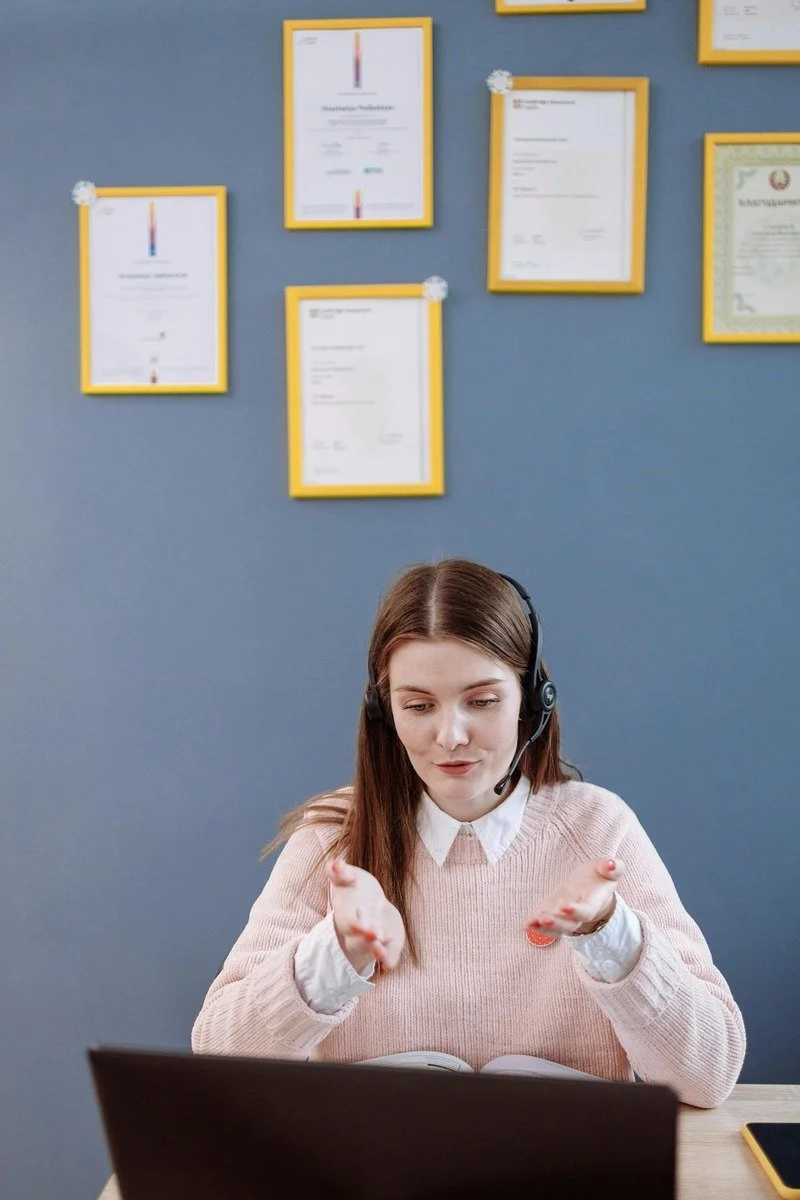 Woman with a headset on talking on a meeting