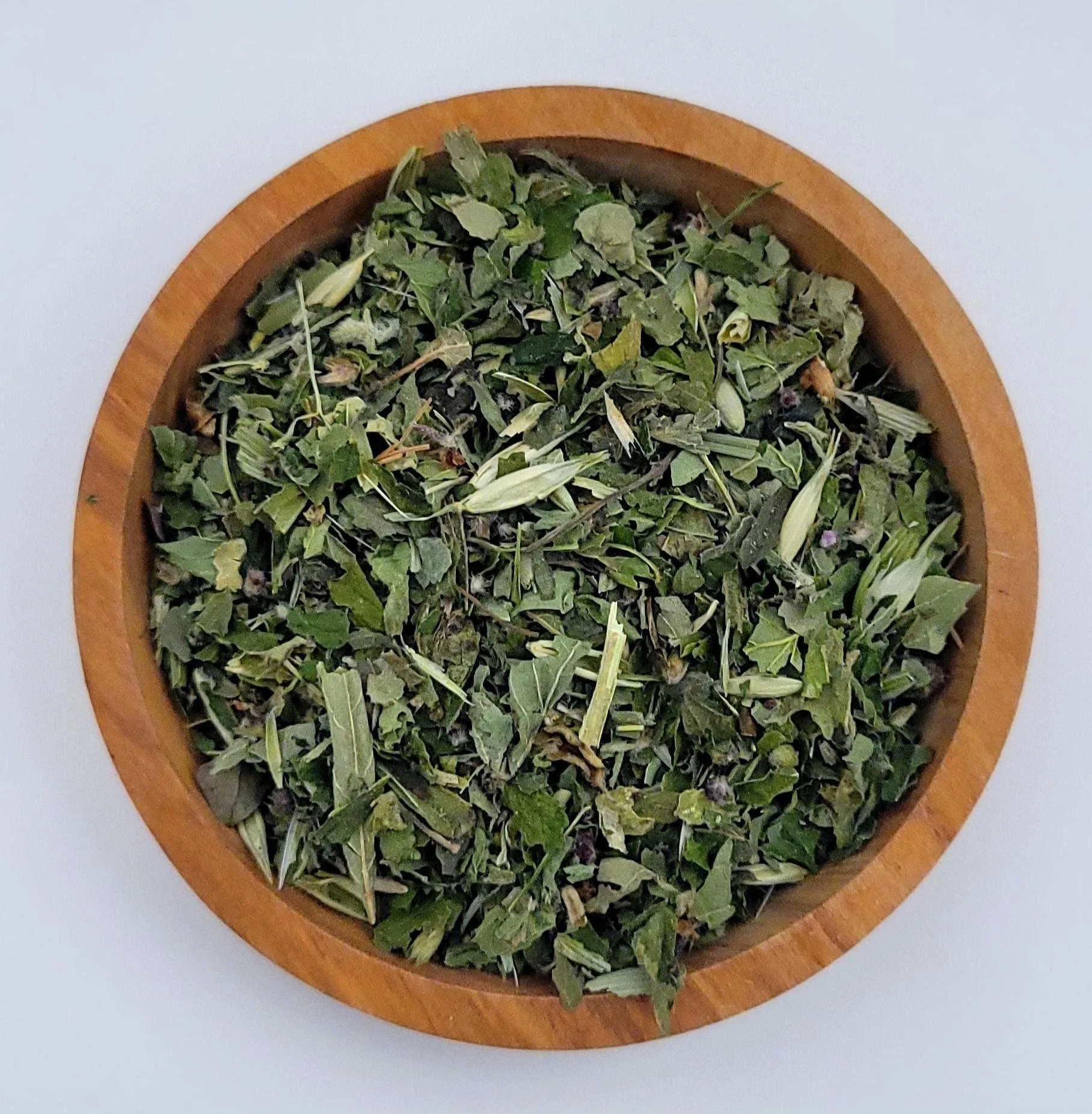 lemon balm loose leaf herbal tea tisane in wooden bowl