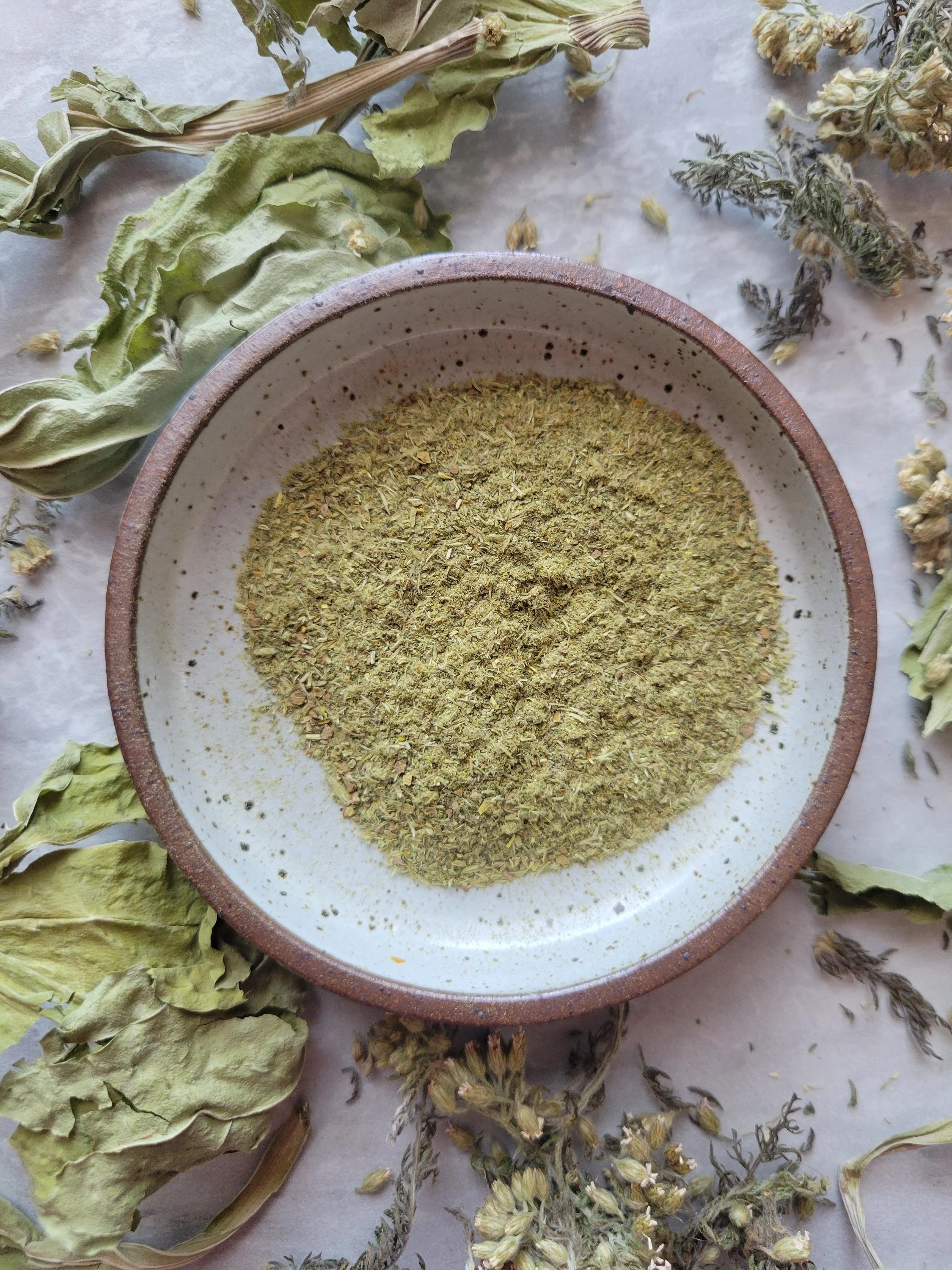 scratch and scrape dust in bowl with herbs surrounding it