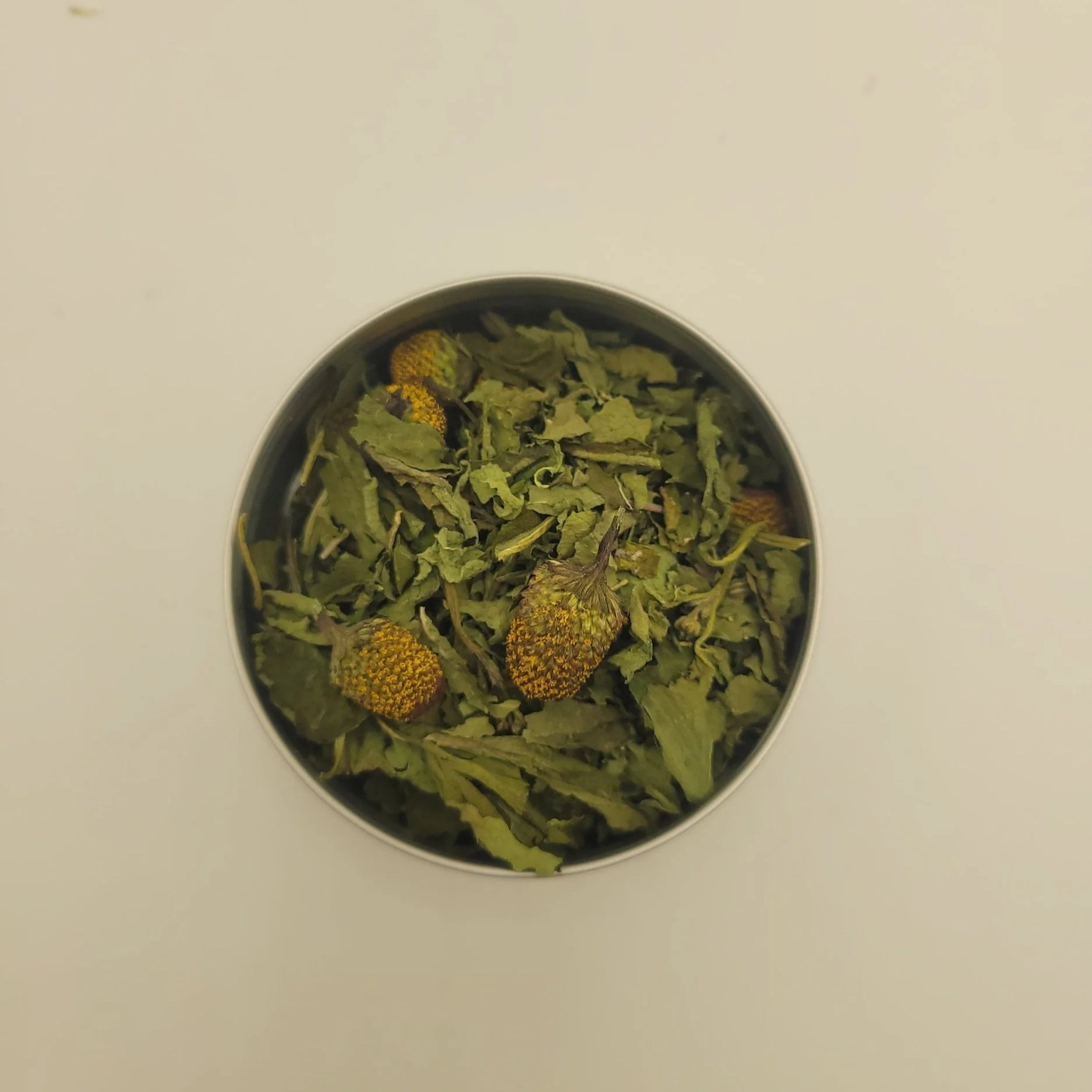 Spilanthes dried herb in small bowl