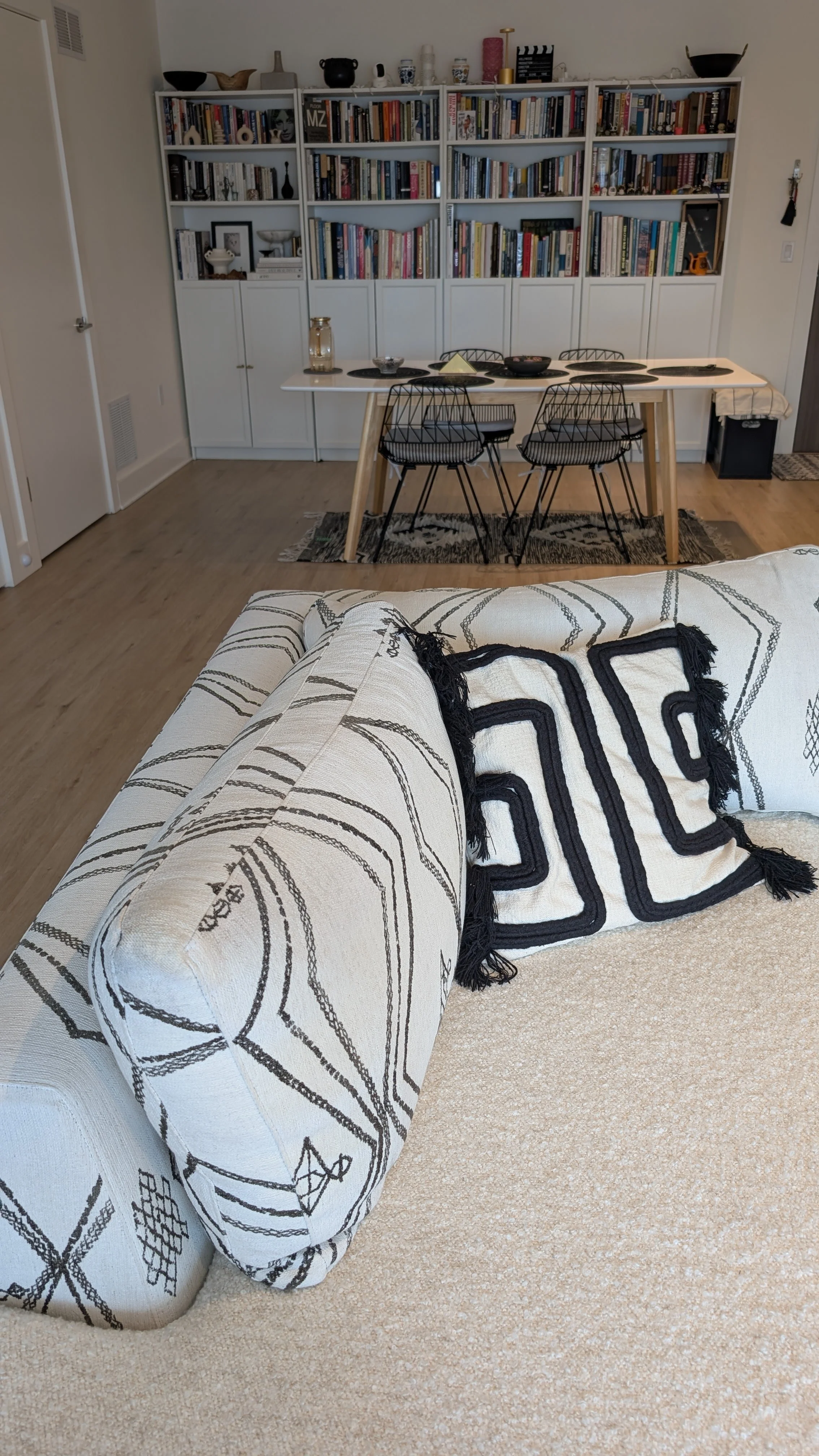 Living room with a custom patterned sofa and a throw pillow.