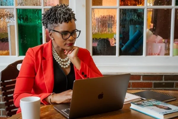 Dr. Agena Davenport reviewing notes, women’s health physician and speaker.