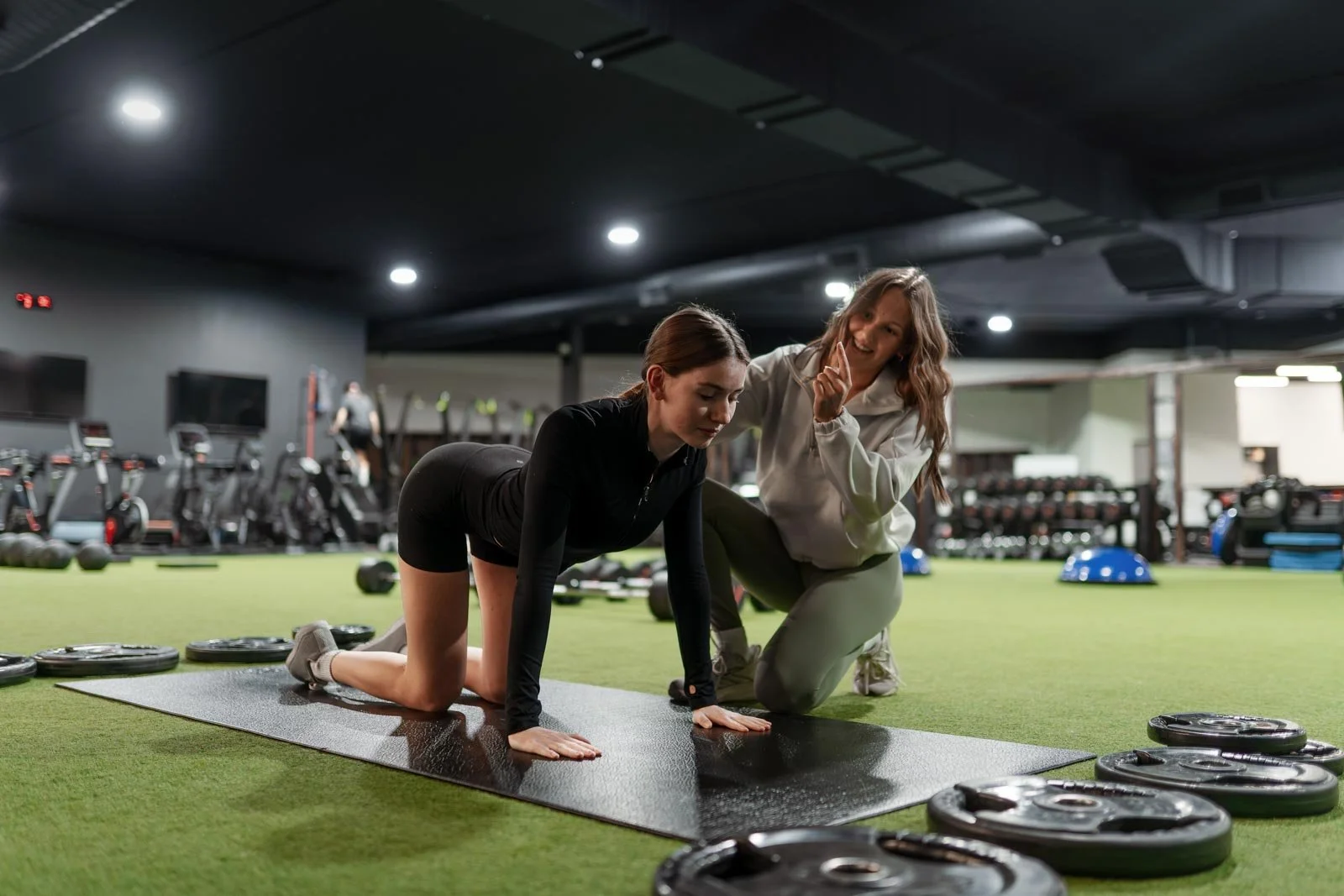 Fitness coach Ella Vrbanac from Ellavate Fitness giving her client tips