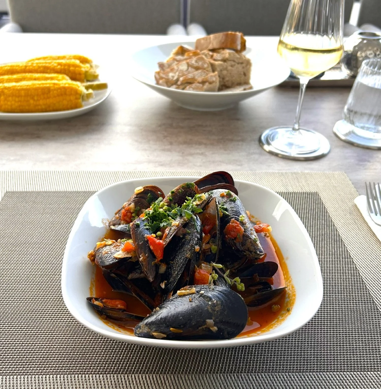 Plated mussels served as part of a private dinner menu.
