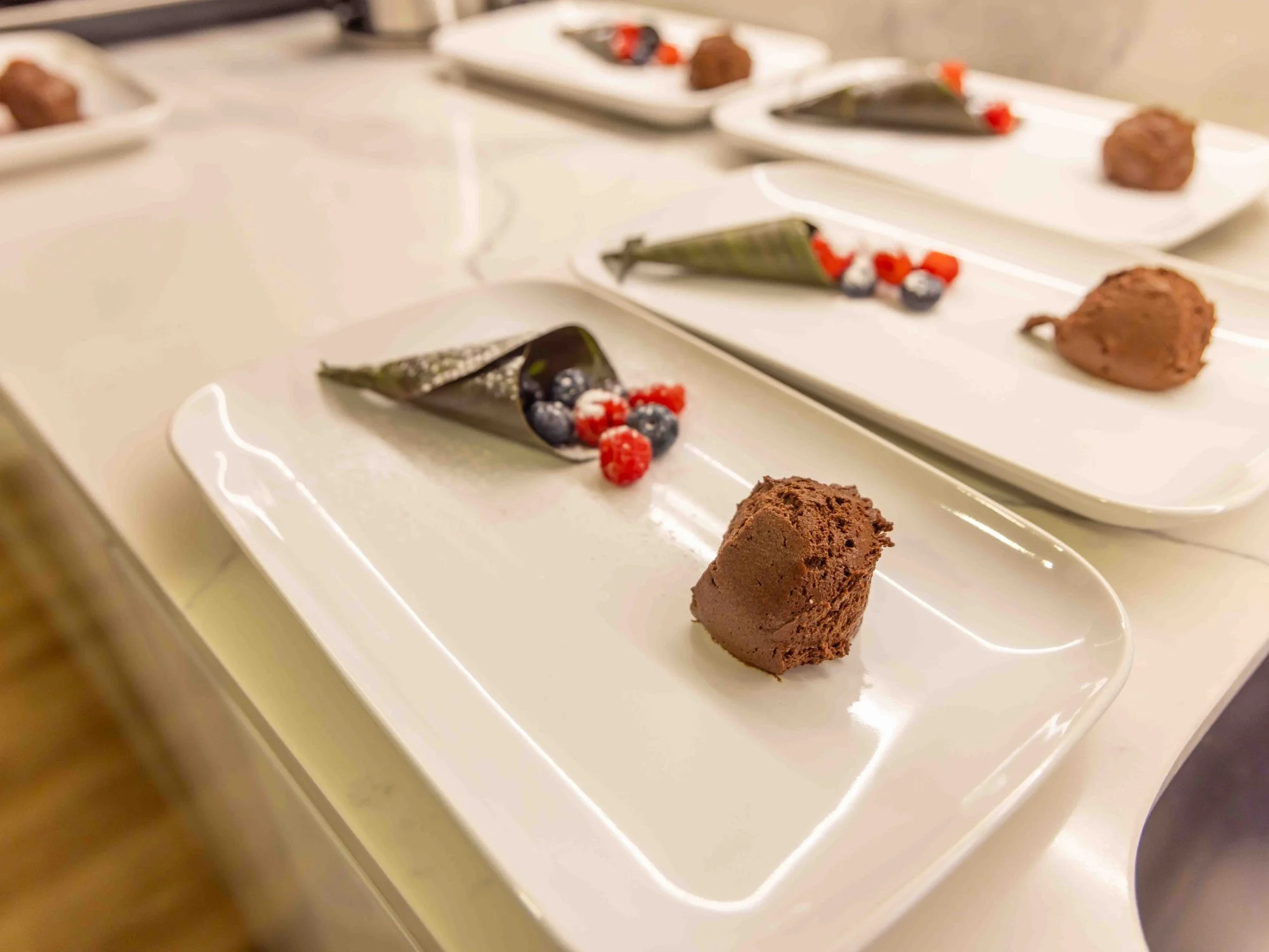 Chocolate mousse dessert served with fruit and berries.