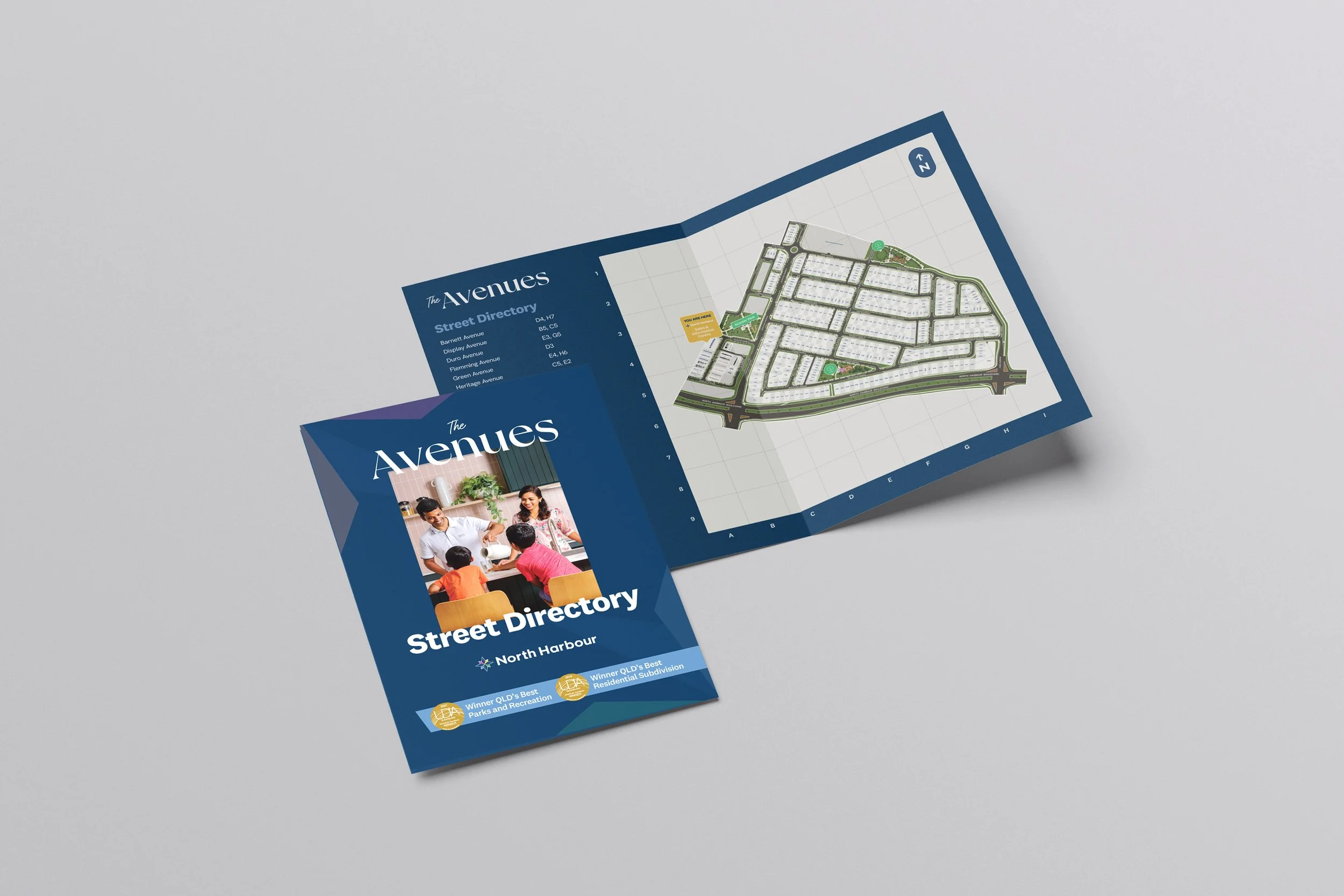 A street directory map and brochure for The Avenues neighborhood in North Harbour, featuring a detailed layout of streets, parks, and recreational areas.