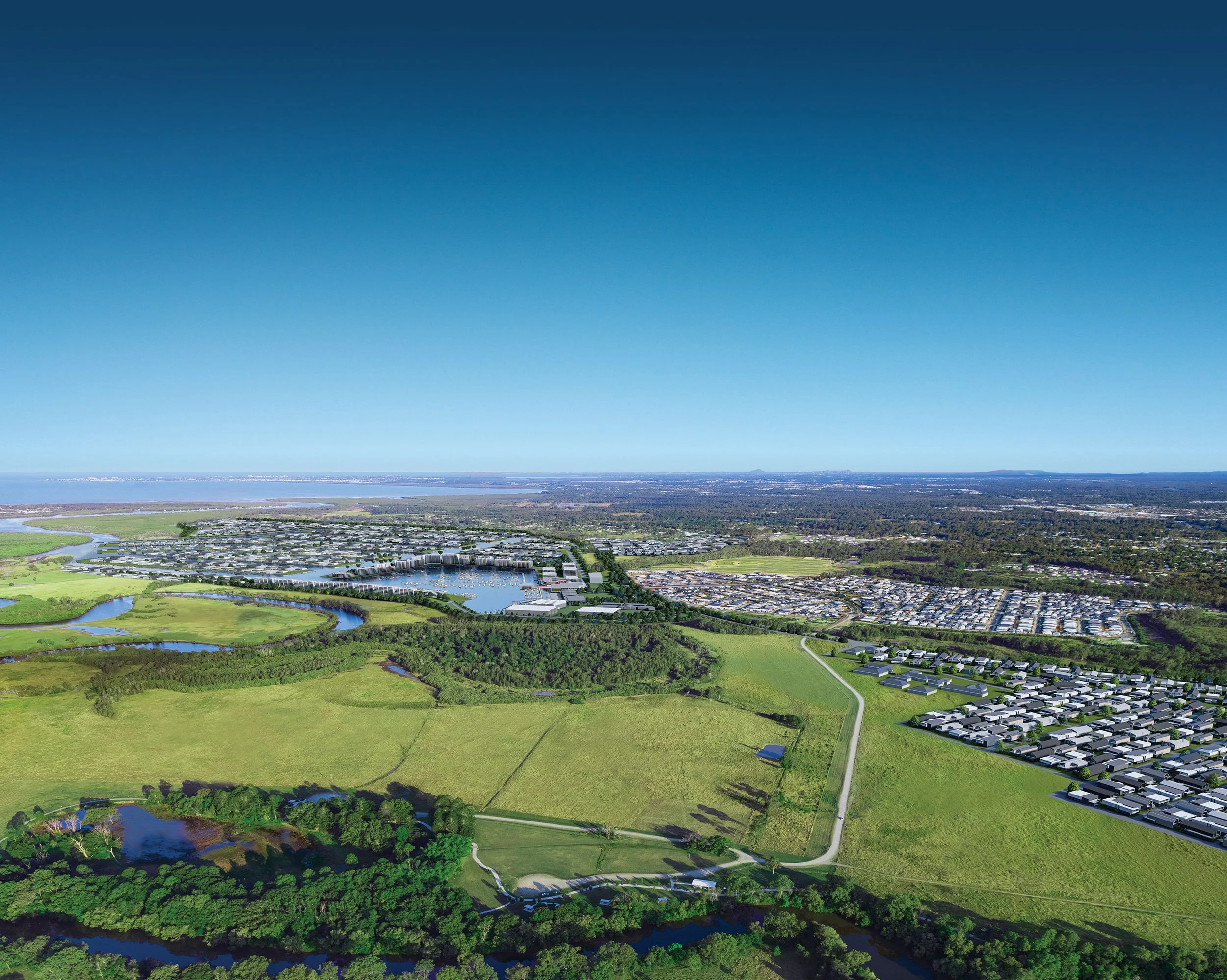 Aerial view of suburban area with water bodies, green parks, residential neighborhoods, and a distant coastline under a clear blue sky.