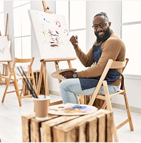 Painter working at an easel in a studio