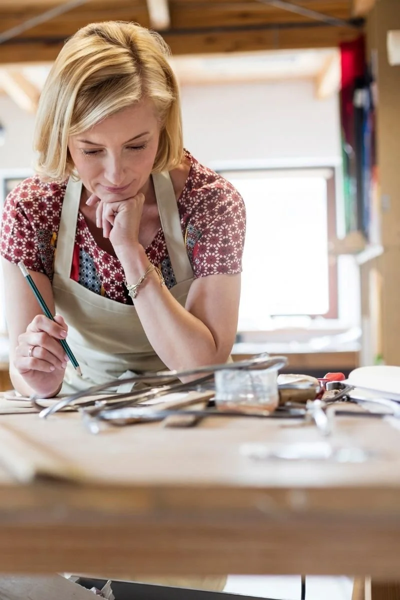 female-artist-working-at-a-crafting-table.jpg