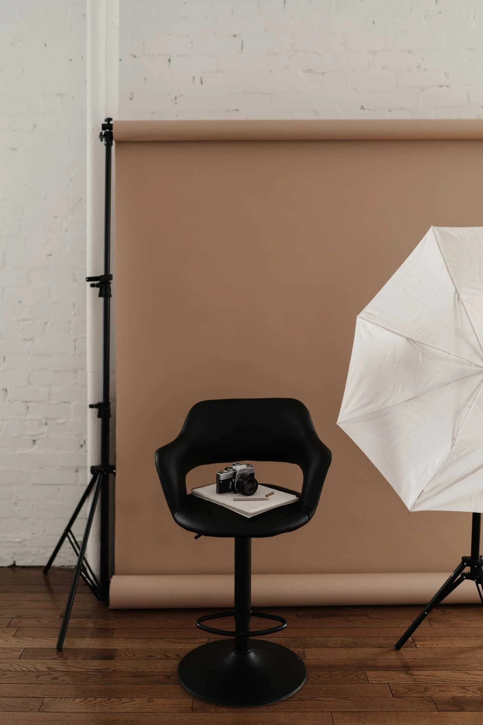 Photography studio setup with backdrop, chair, and camera representing a creative workspace