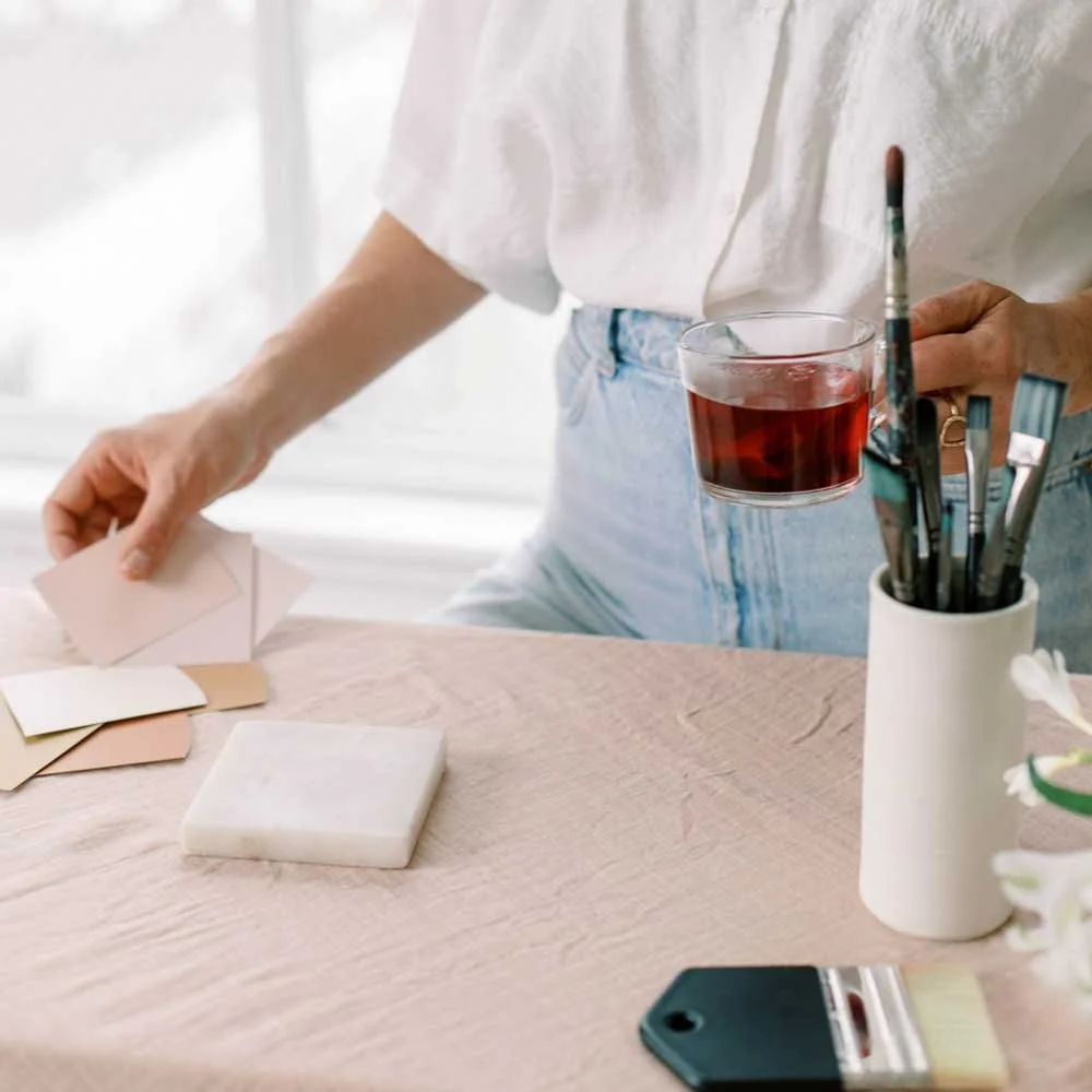 Hands working with creative tools on a desk