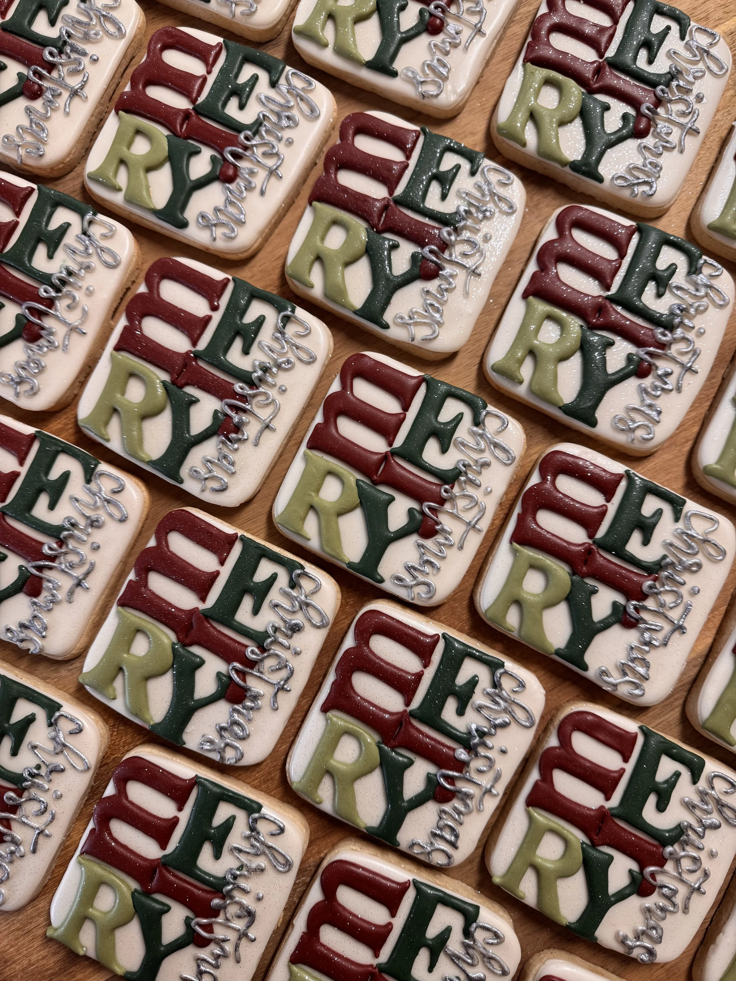 Decorated Christmas cookies with the words 'MERRY' and 'CHRISTMAS' on a white background.