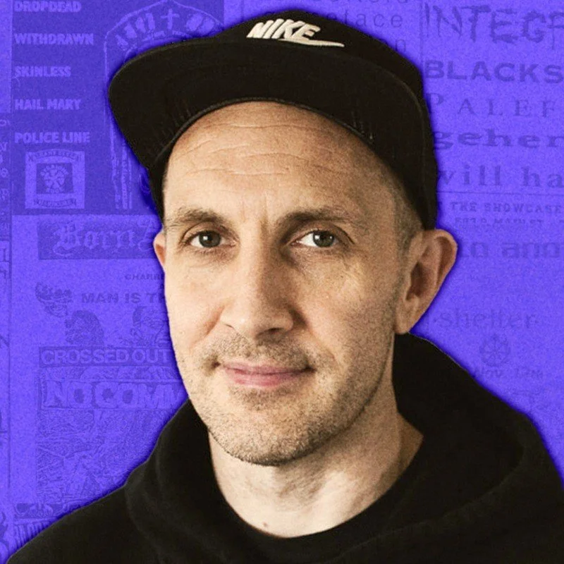 Popular metal and alternative music and culture YouTuber Finn McKenty, wearing a black Nike cap and black hoodie, standing in front of a purple background with various text and graphics.