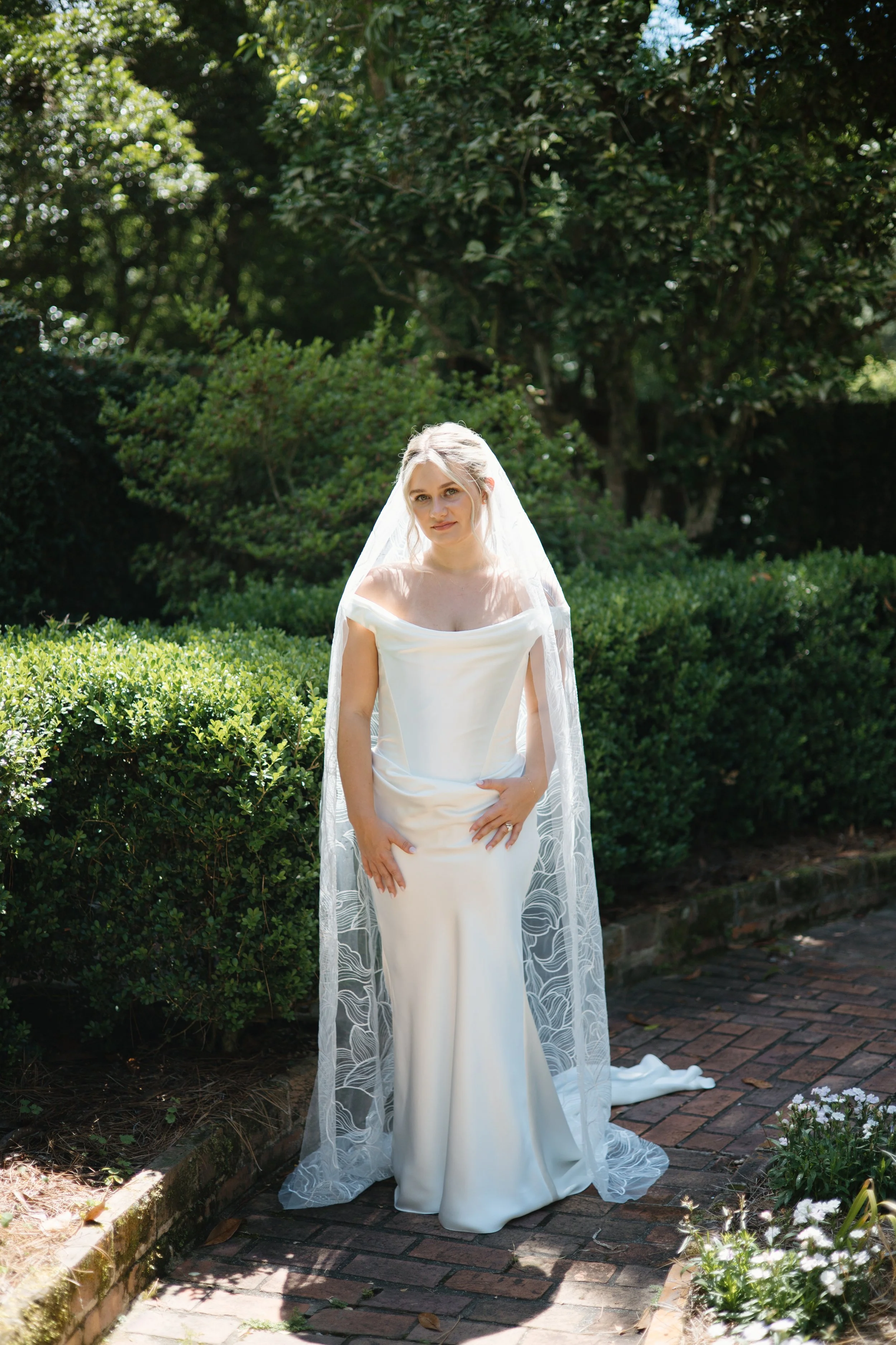 Bride posing for solo portraits in the sun at Maclay Gardens State Park