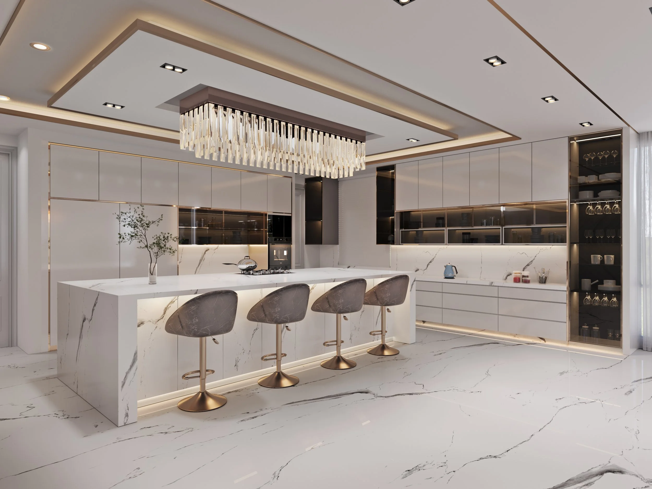 Modern kitchen with white marble countertops and flooring, above-counter cabinets, and an island with four bar stools. Gold accents and a chandelier hanging from a recessed ceiling design.