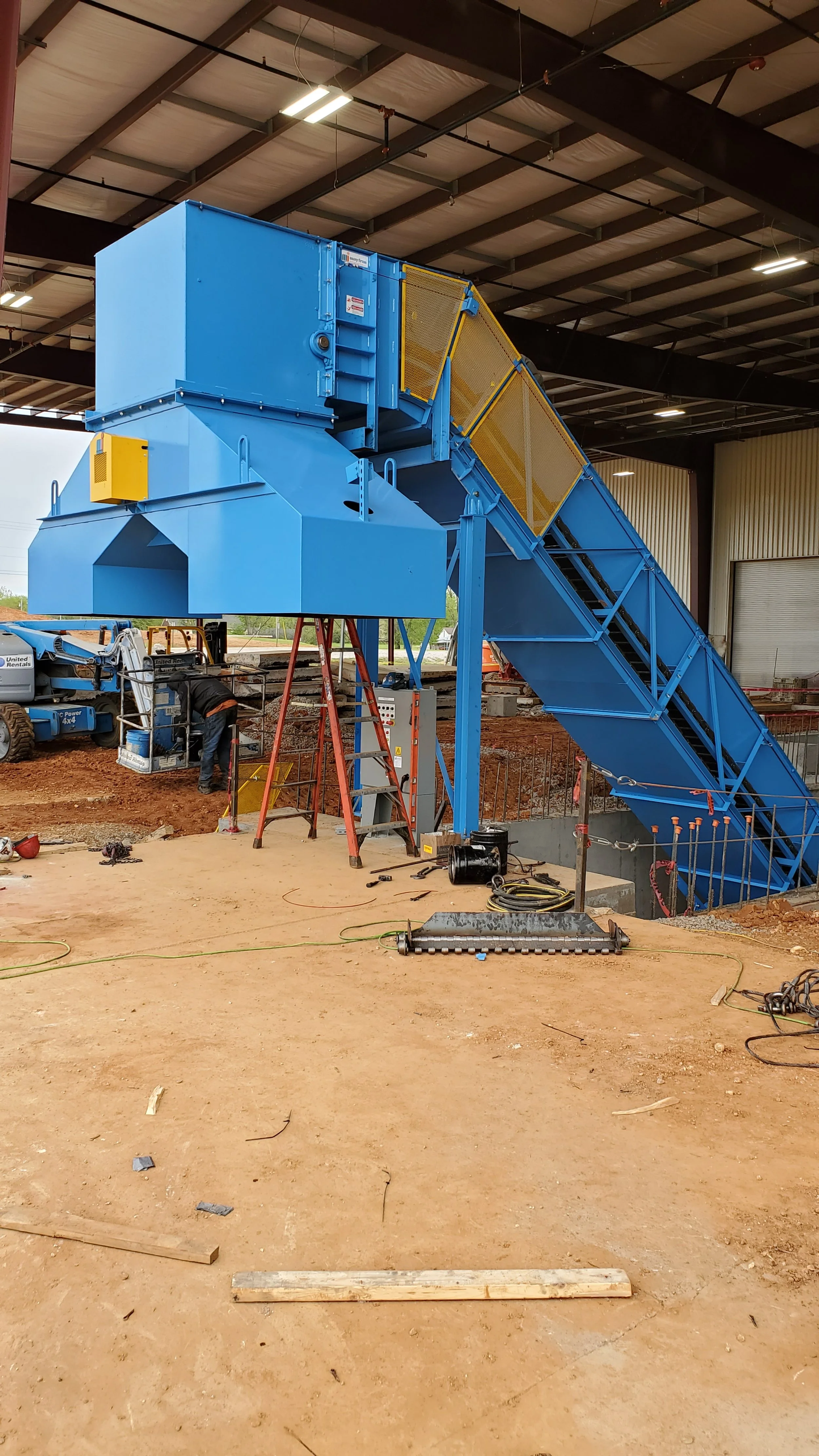 An image of a blue conveyer showcasing CMC industrial conveyor installation.