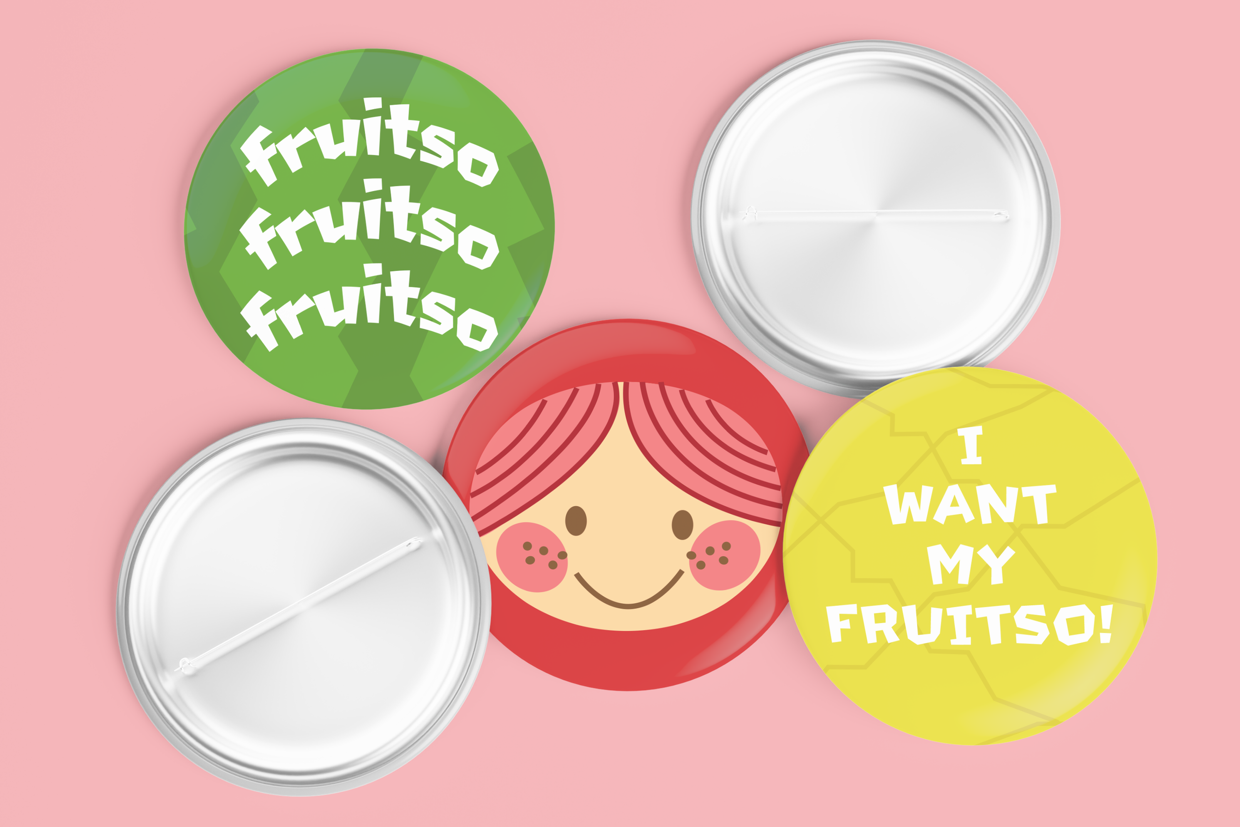 Assorted pins with "fruitso" on one, a smiling face on another, and "I want my fruitso" on another
