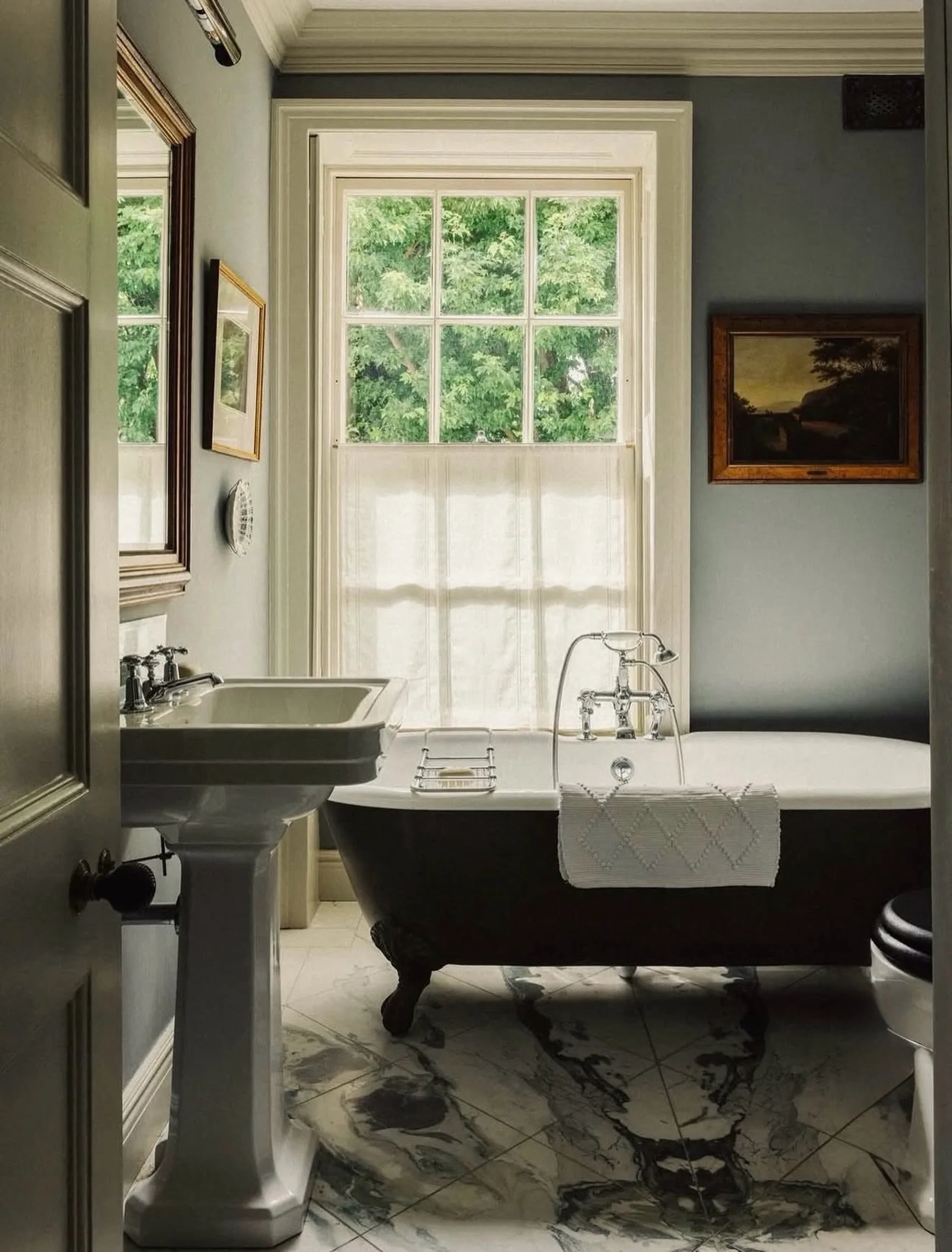 S O A K
A little drama. A lot of restraint.🛁

The dark clawfoot tub, pale blue walls, and marble underfoot make a compelling case for treating the bathroom as more than a functional space. Every element earns its place.🫧

Photography: @mark_anthony
