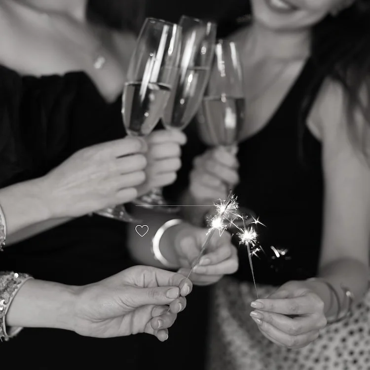women clinking champagne glasses