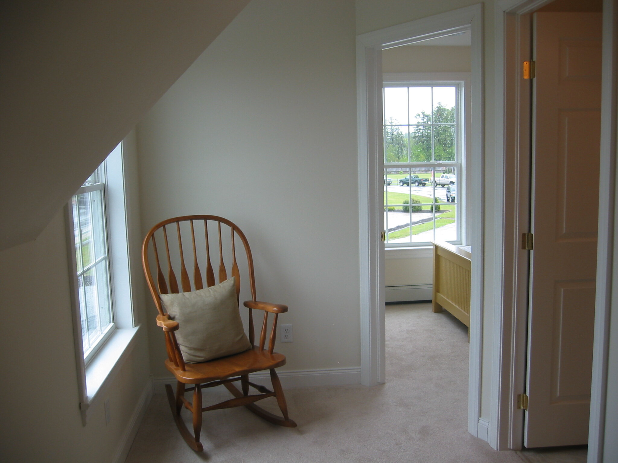Hallway with secondary bedroom and entrance into bathroom at right.