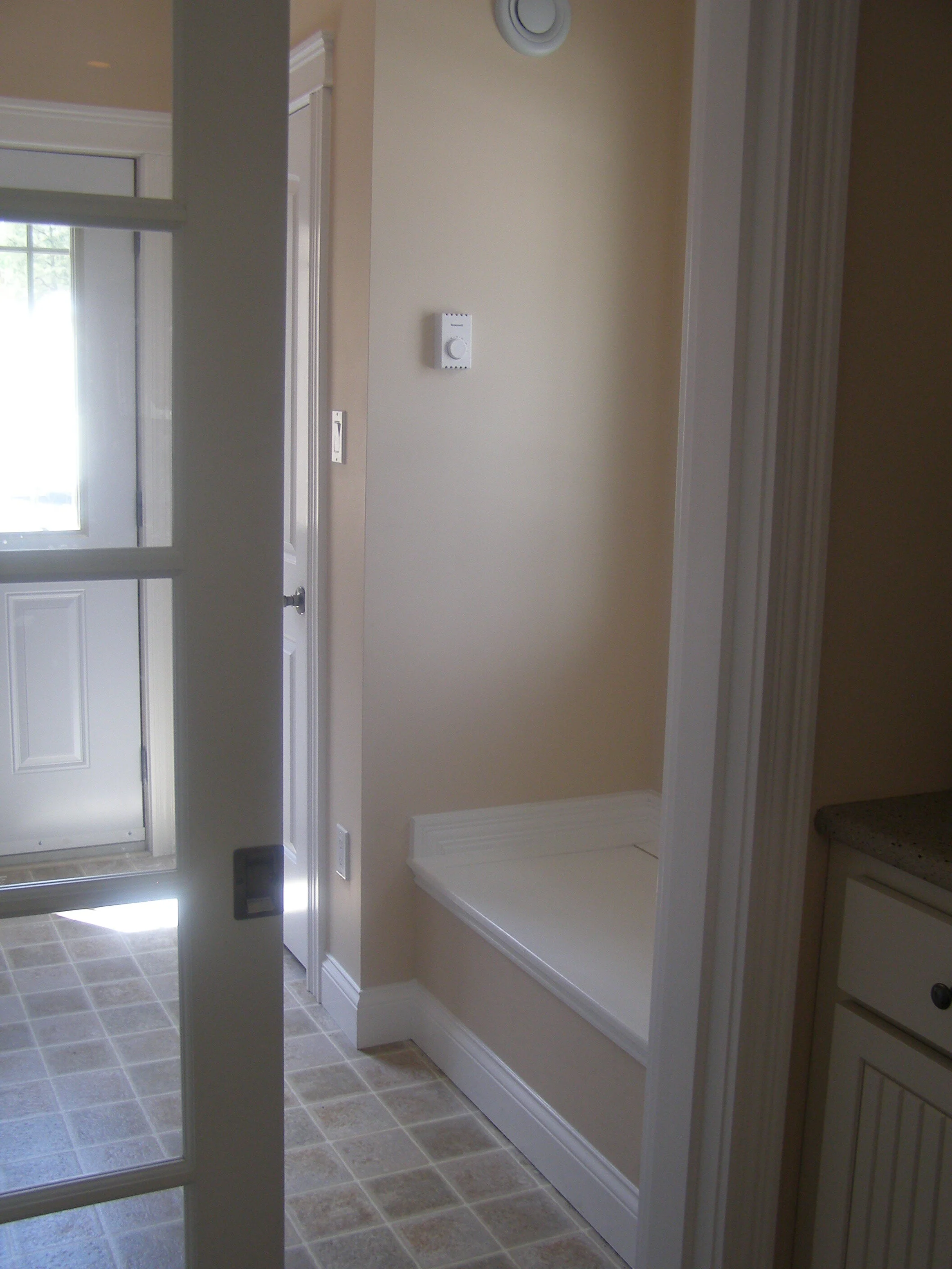 Glass Pocket door into Side Entry w/ storage bench.