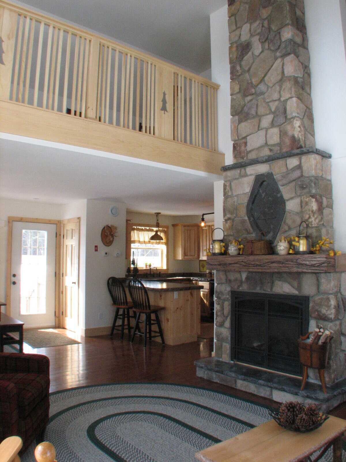2 Story Stone Fireplace with concrete mantle and insert.