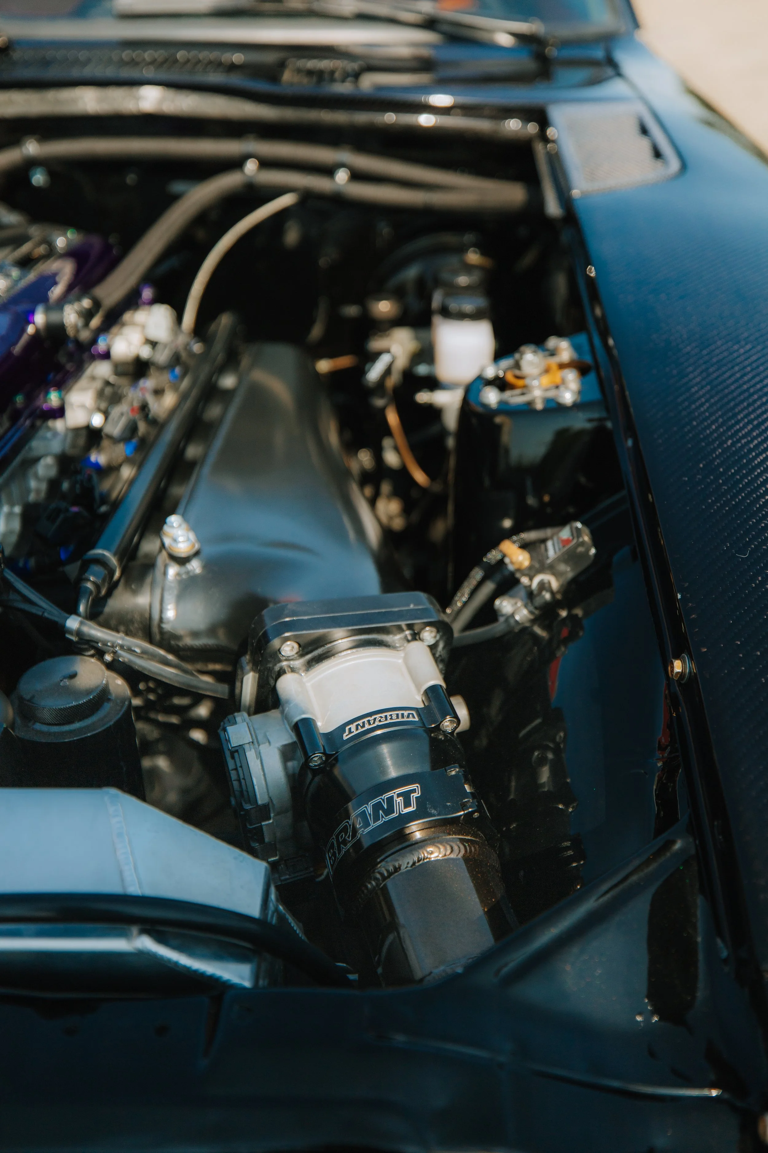 Close-up view of a high-performance car engine, showing various mechanical parts and components.