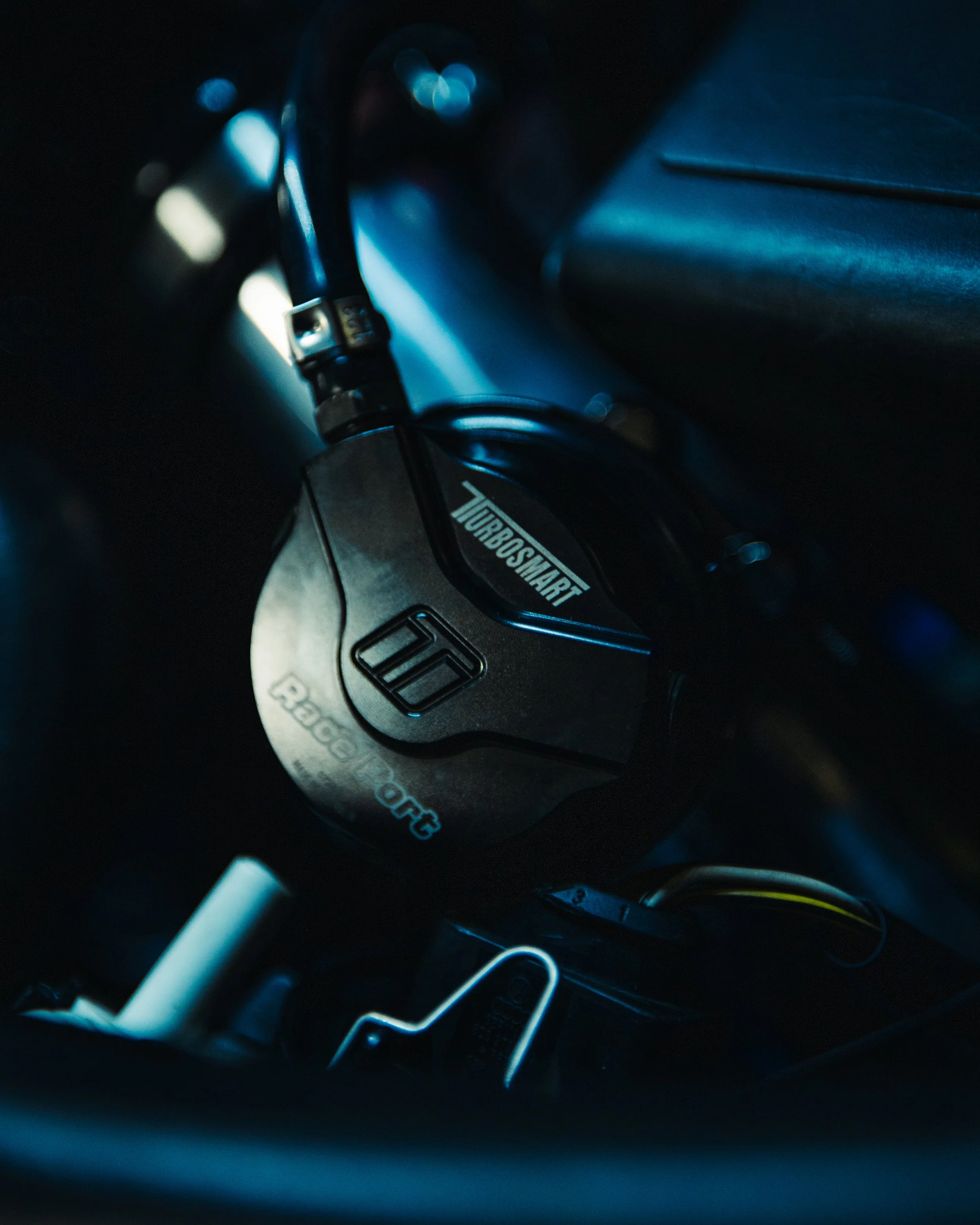 Close-up of a gear shift knob with branding and labels, including 'TURBOSMART' and 'BOOST.ORG', in a car interior.