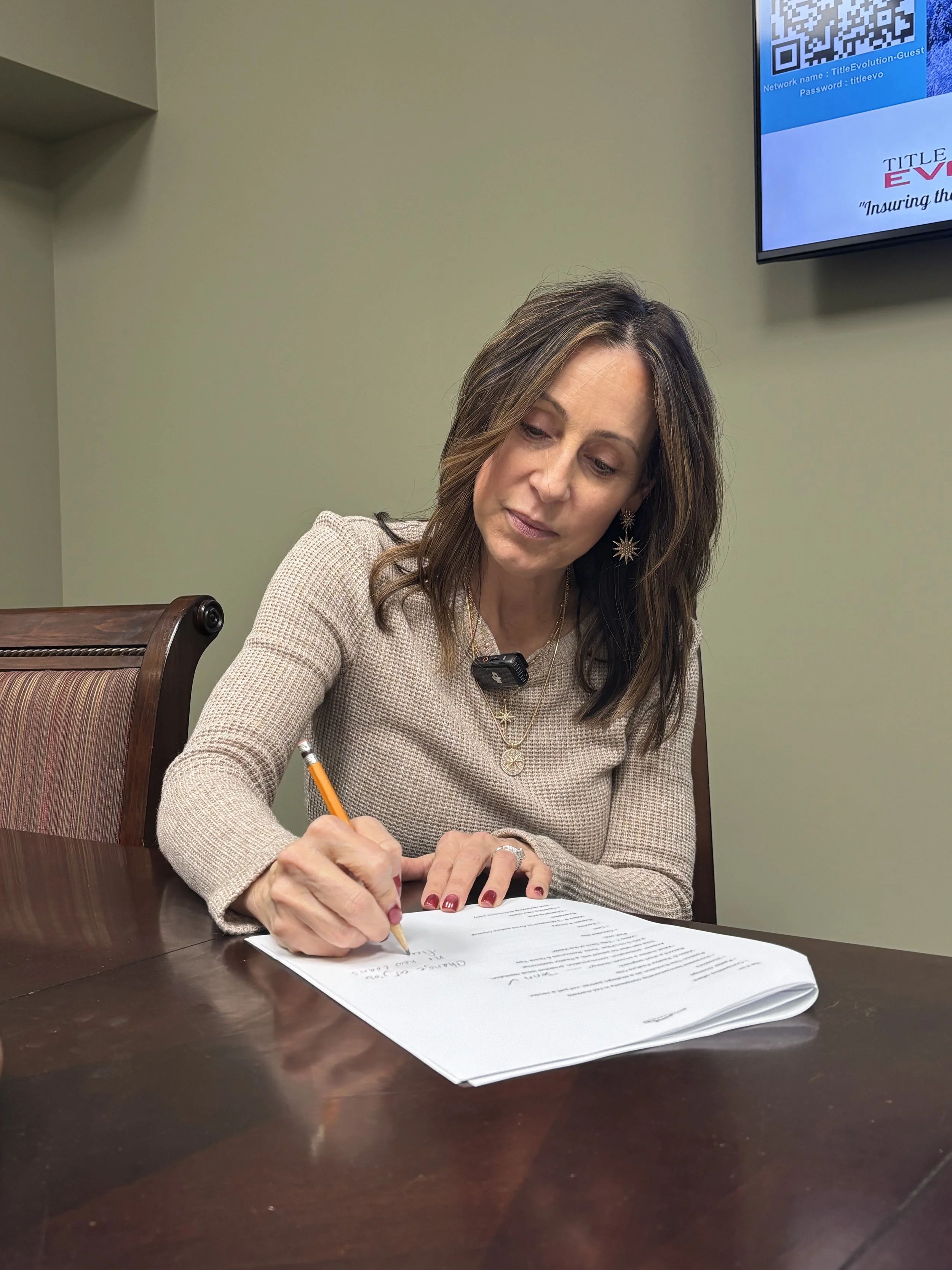 Partner, Jennifer Costner, at the Title Evolution closing table.