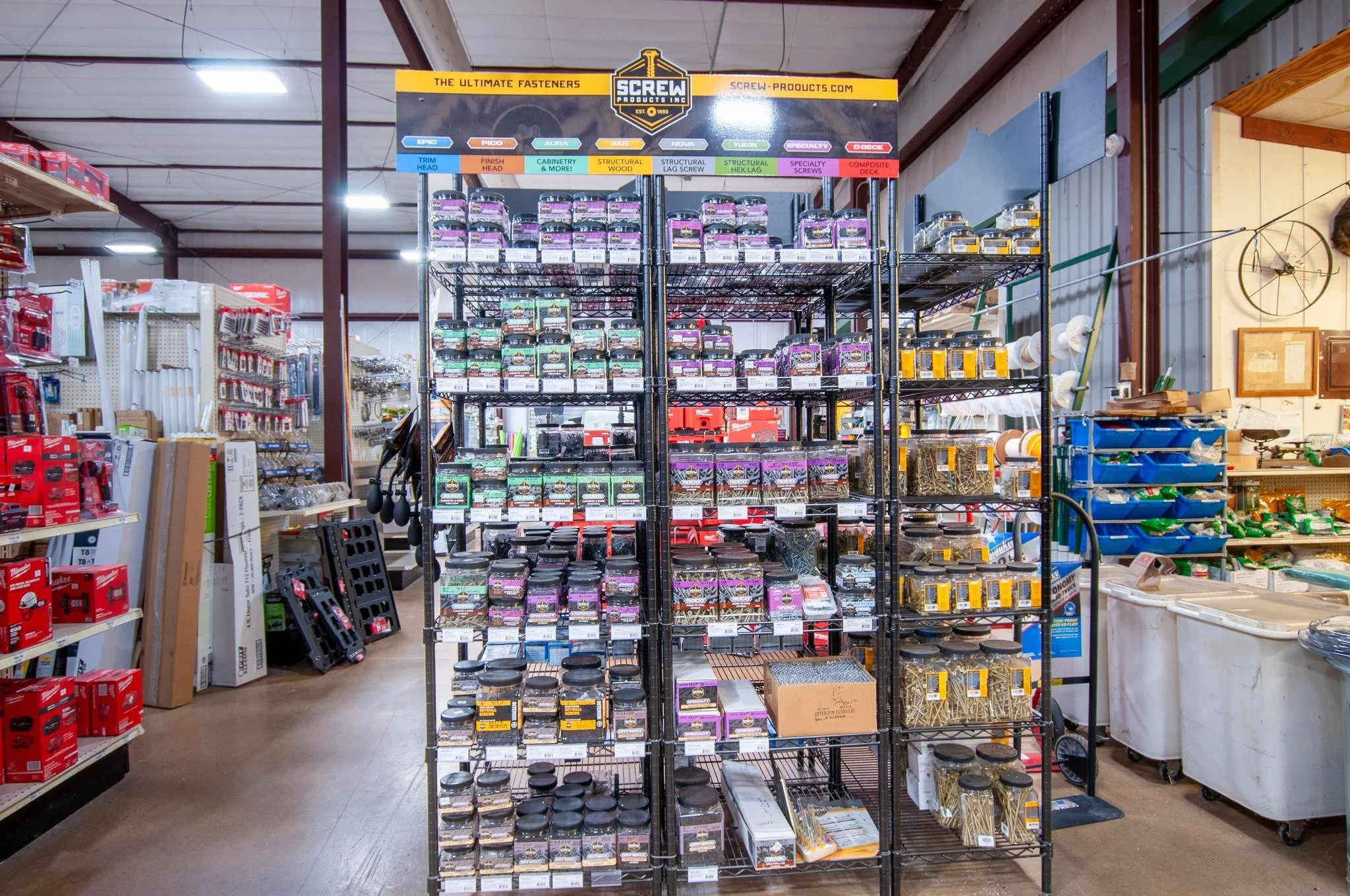 Shelf displaying various screws and fasteners organized by type and size in a hardware store.