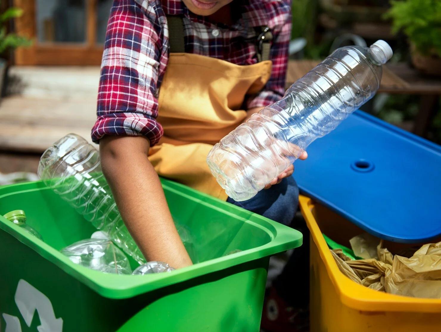 Close up of child's hands separating plastic bottles