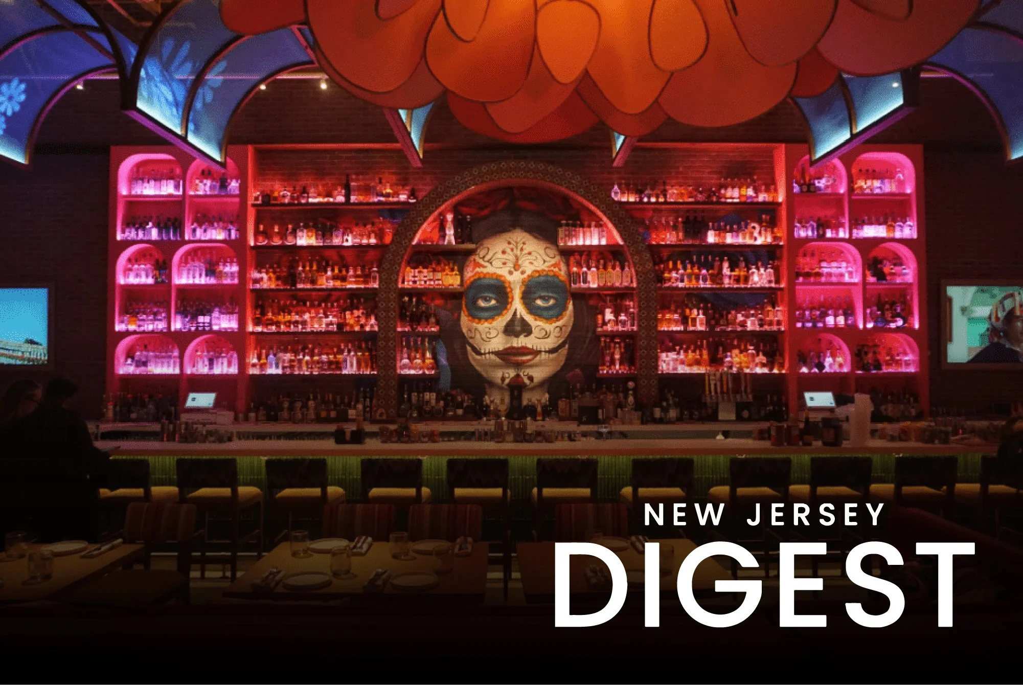 A vibrant bar with a large painted face of a woman resembling a sugar skull, surrounded by colorful lit shelves of liquor bottles. Dining tables are set in the foreground, and the scene is illuminated with pink and purple lighting.
