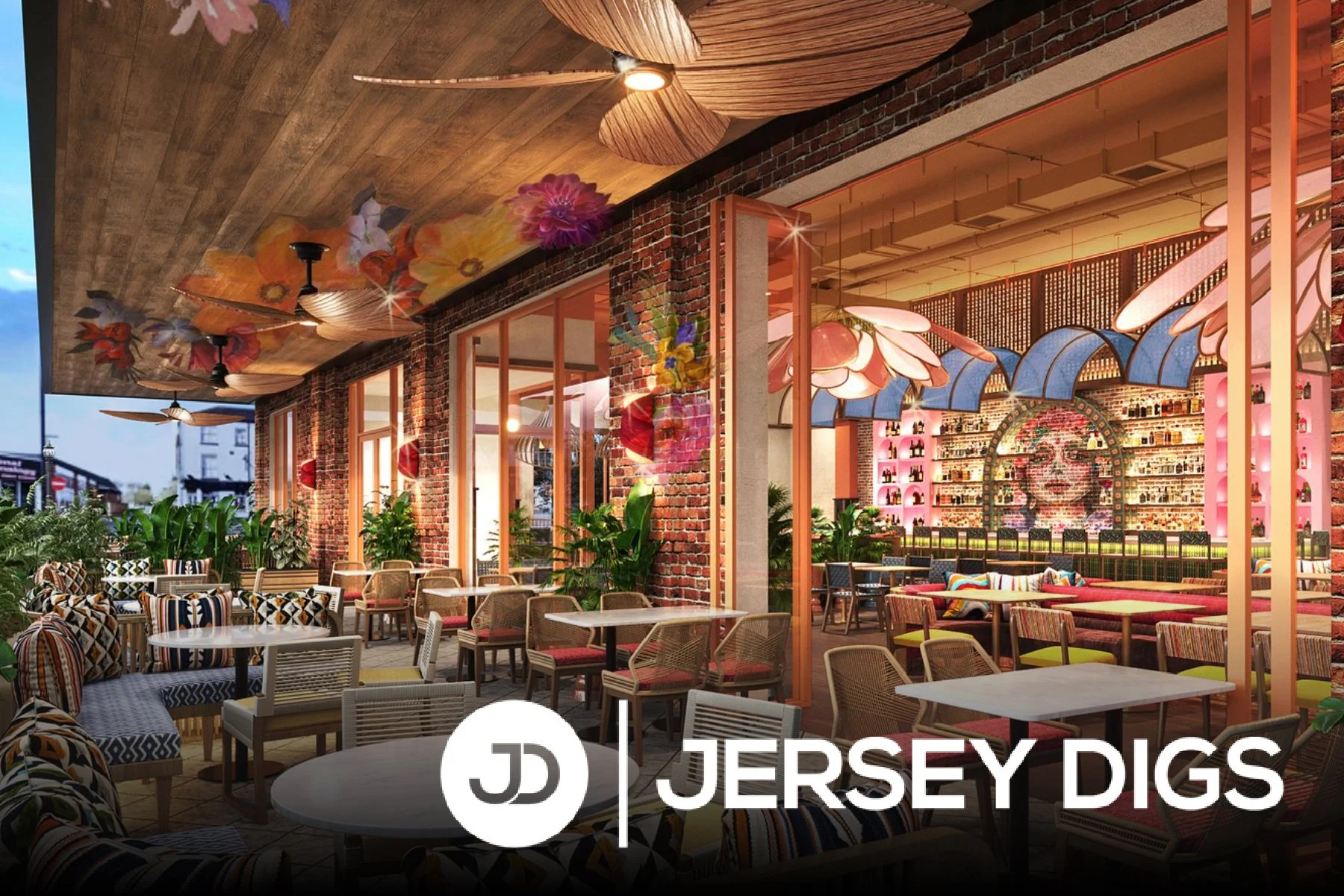 Brightly decorated restaurant with brick walls, wooden ceilings, and colorful floral and face murals. Indoor and outdoor seating with patterned chairs, plants, and large flower-shaped light fixtures.