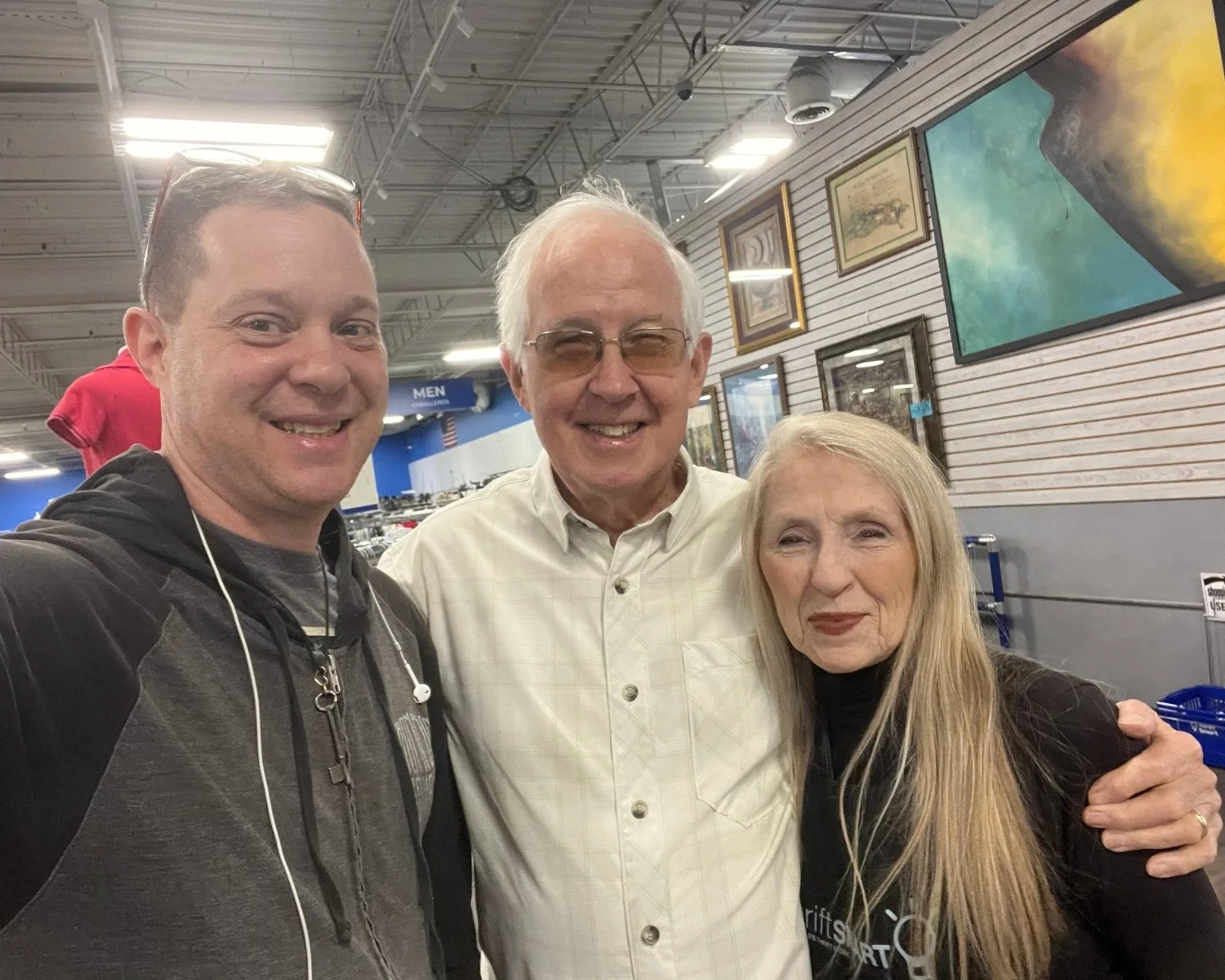 Mac Kelton smiling with Josh and Rhonda at ThriftSmart