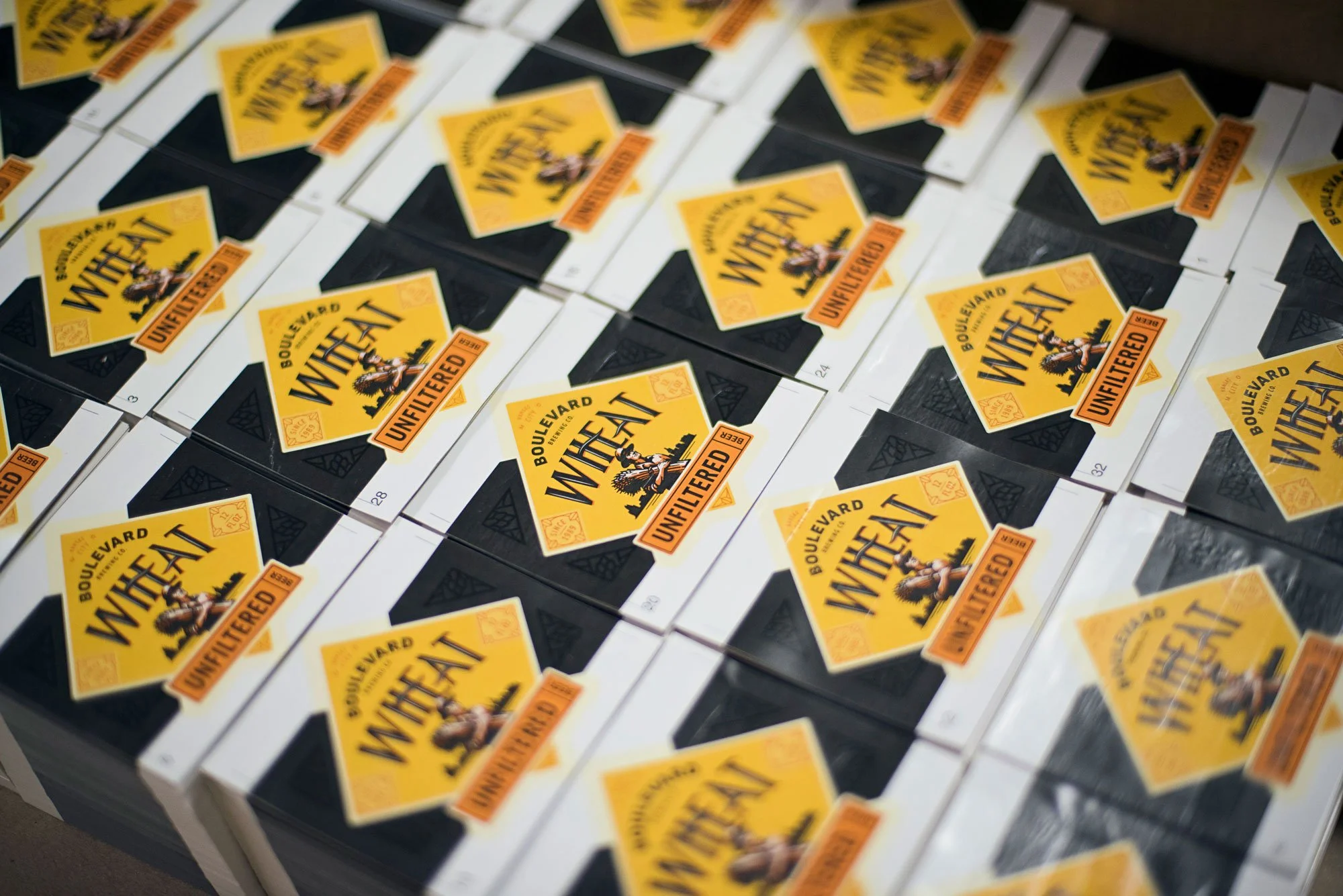 Multiple packages of Boulevard Wheat beer stacked on a table.