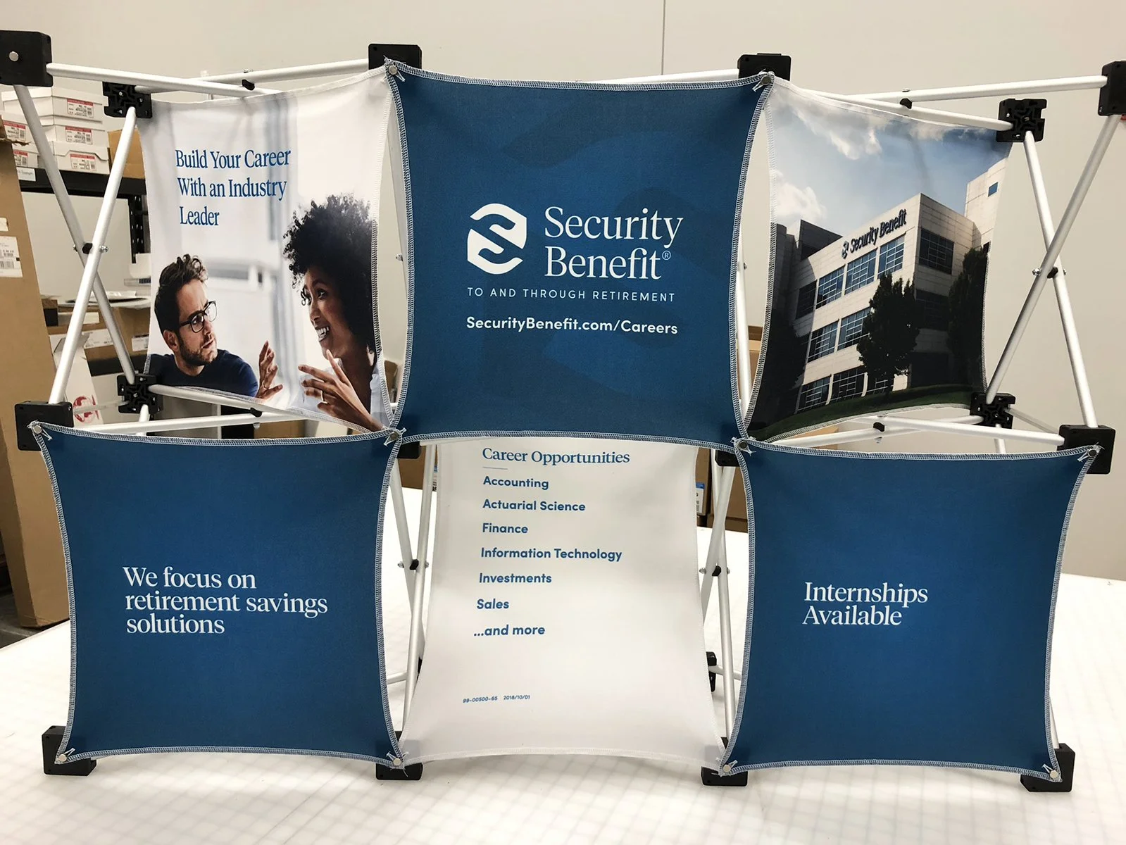 Brochure display for Security Benefit featuring career opportunities, internship availability, and retirement savings solutions; includes a company logo and building image.