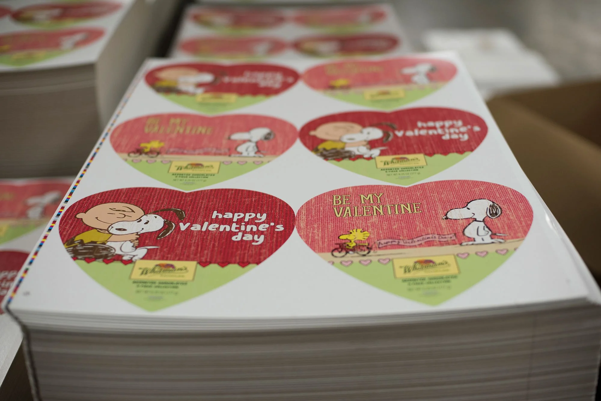Stack of stickers with Valentine-themed Peanuts characters and messages like "happy Valentine’s day" and "BE MY VALENTINE."