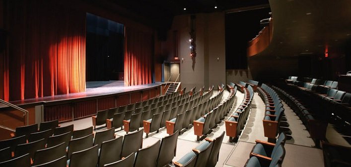 Empty theater with a stage and rows of empty seats. The Algonquin Theatre.  The Riverbend Condos, Huntsville, Muskoka.