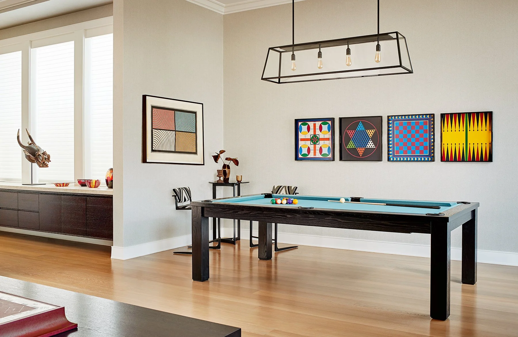 A game room with a pool table and colorful abstract artwork on the wall on Filbert Street Pacific Heights in San Francisco