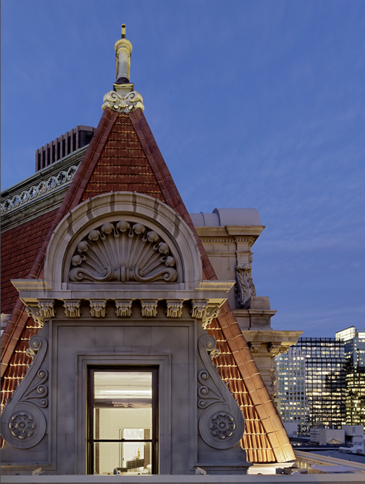 Kearny One rooftop at dusk with ornate historic architectural detailing and sweeping views of downtown San Francisco, capturing the iconic city backdrop for this workplace project.