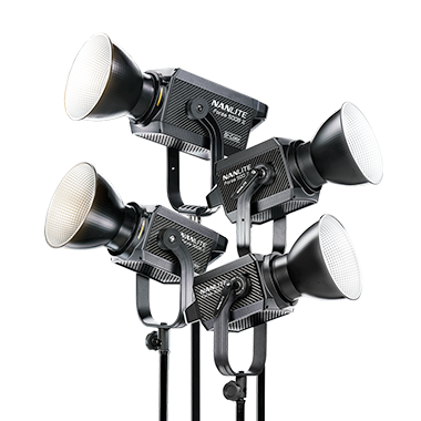 Four professional stage or studio lights with adjustable fixtures and white lenses.