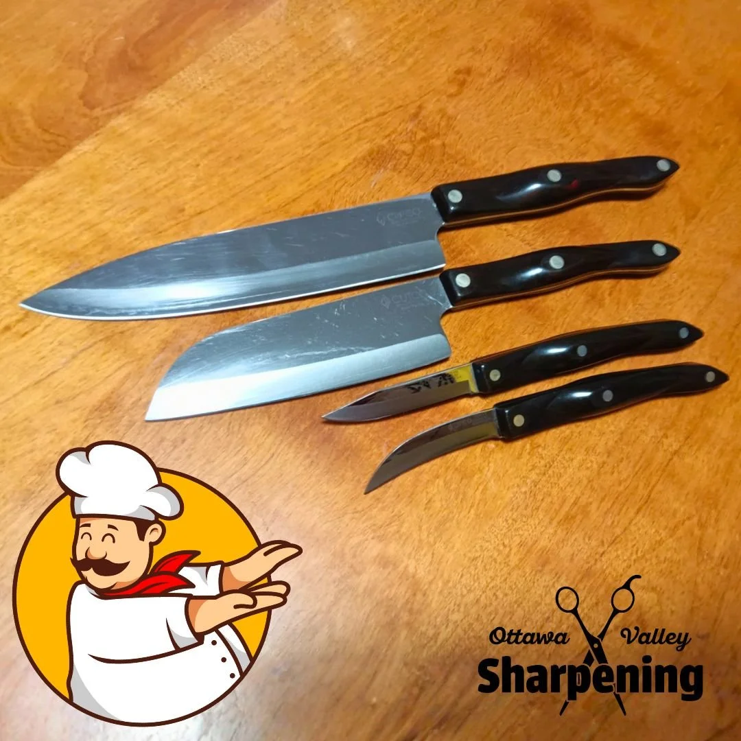 Four kitchen knives with black handles laid out on a wooden surface, with a logo in the bottom left corner featuring a smiling chef cartoon, and a logo in the bottom right corner reading 'Ottawa Valley Sharpening' with crossed scissors.