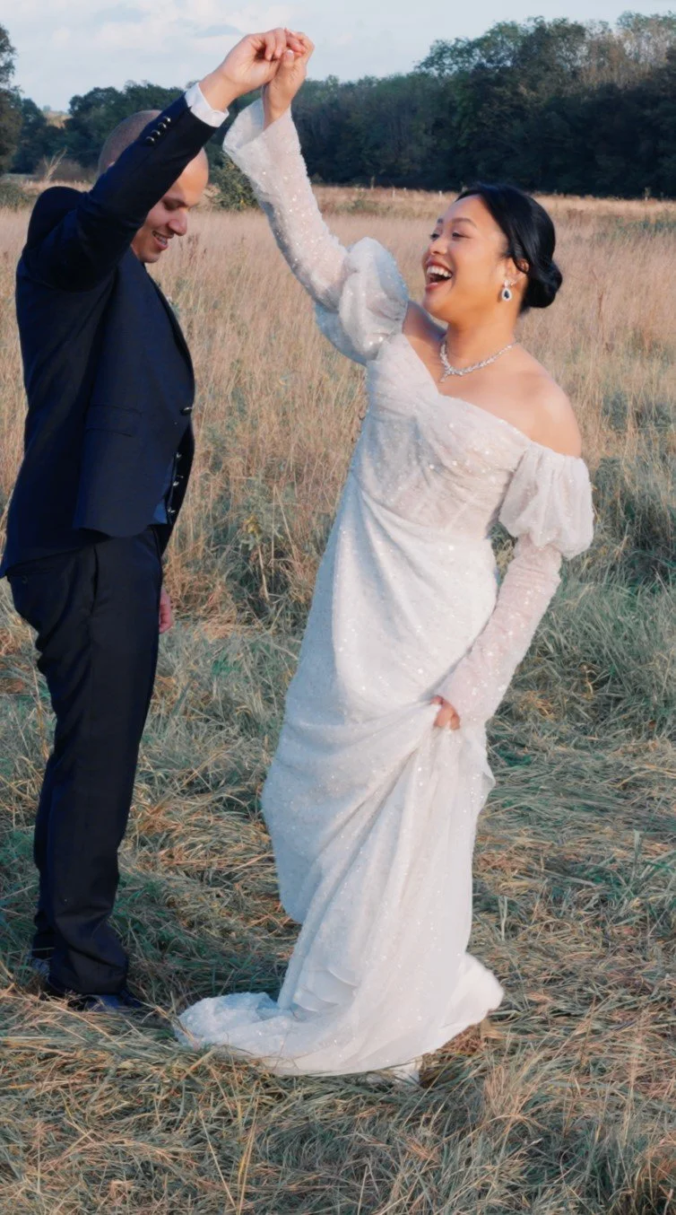 Bride and groom dancing together outdoors during their wedding, captured in a relaxed, candid moment.