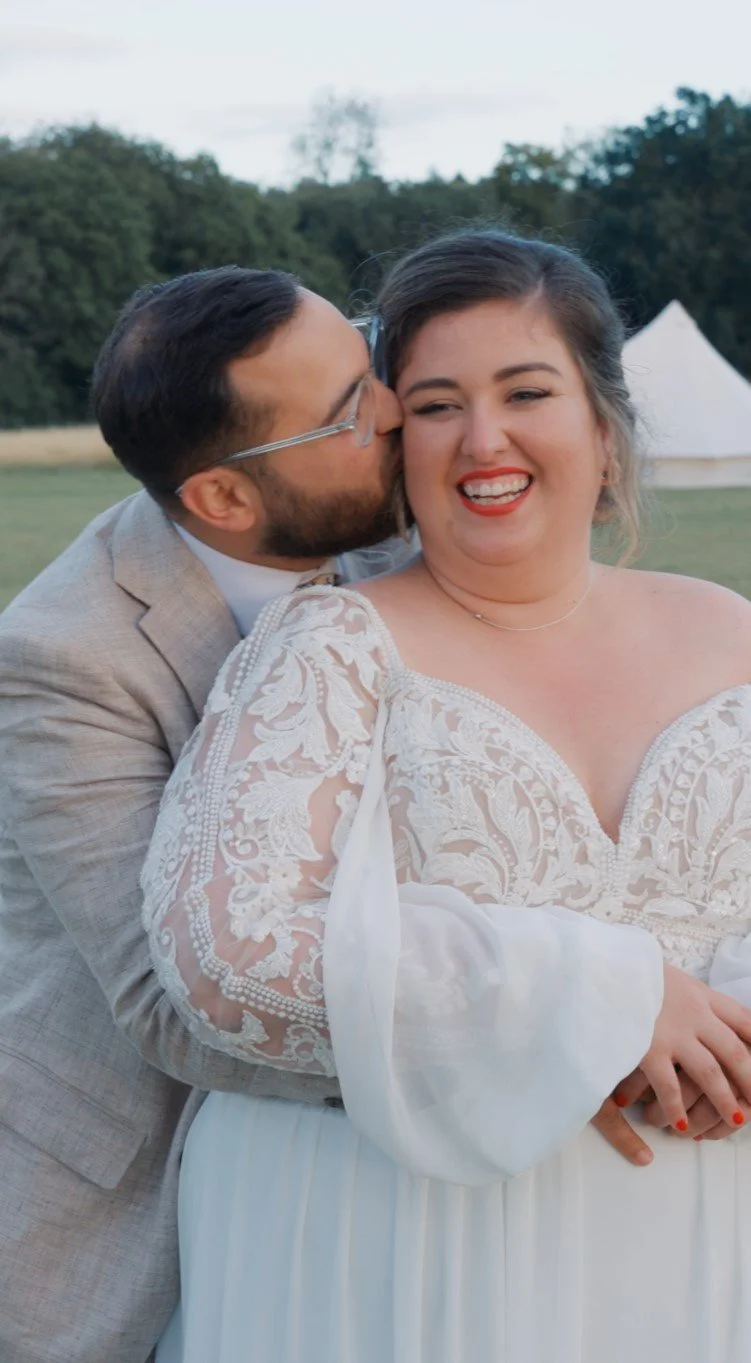 Newlywed couple sharing a joyful moment outdoors after their wedding ceremony.