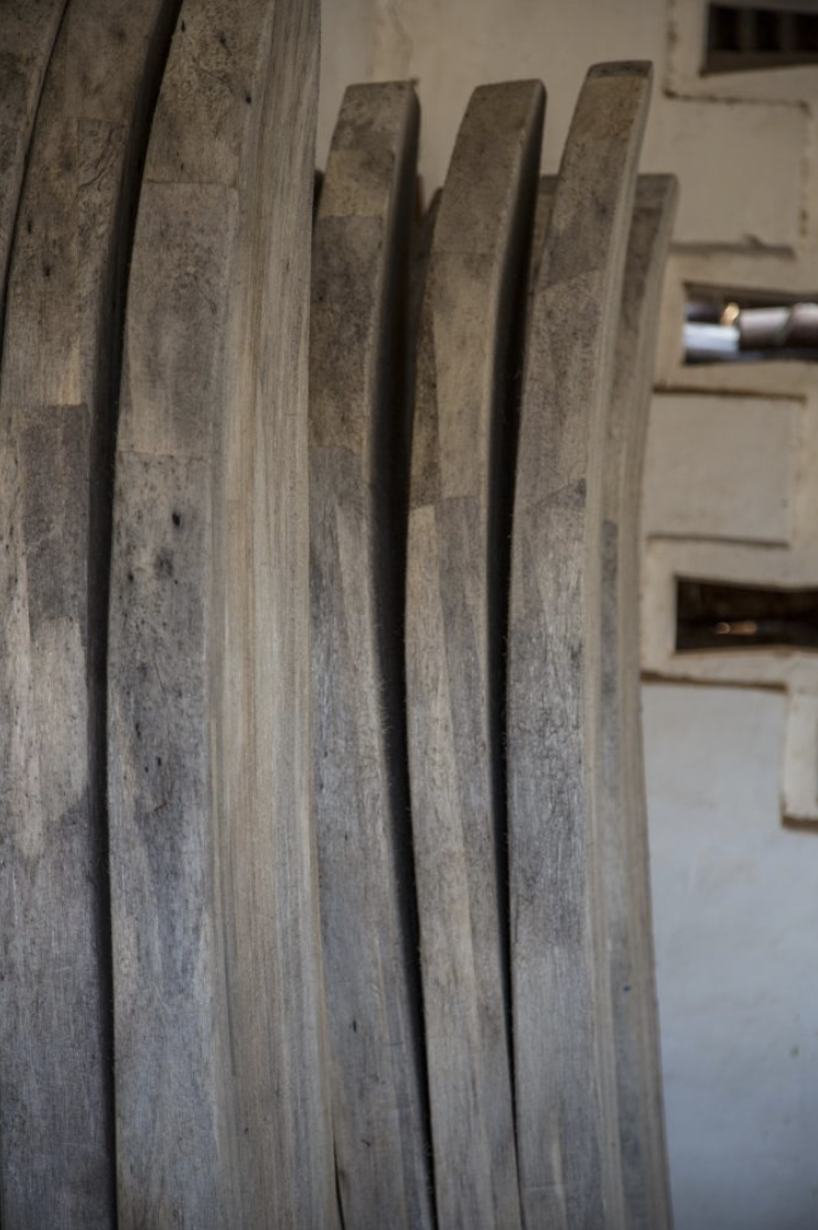 Close-up of several stacked wooden planks with a rustic, weathered appearance.