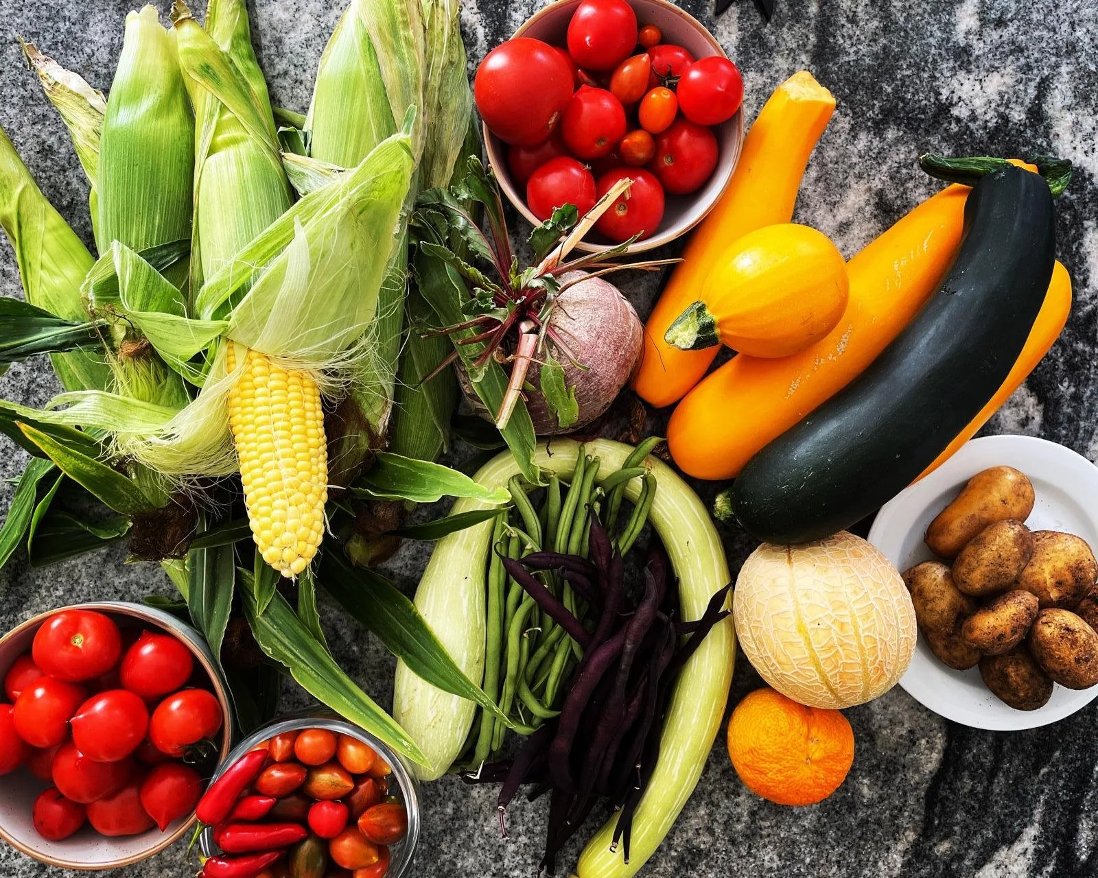an array of different vegetables such as corn, courgette and beetroot